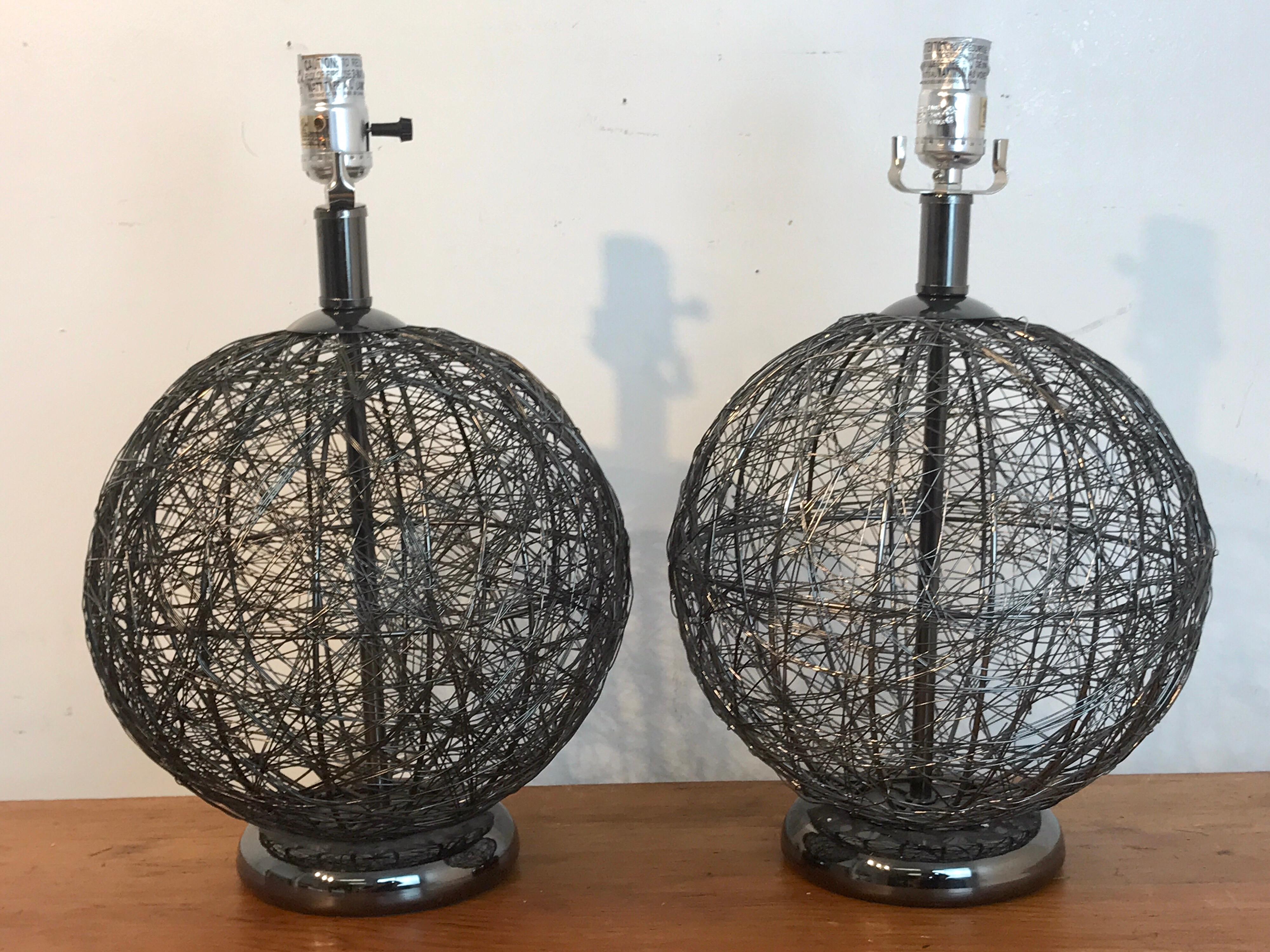 Pair of midcentury spun gun metal sphere lamps, each one of Kinetic form, raised on a 6