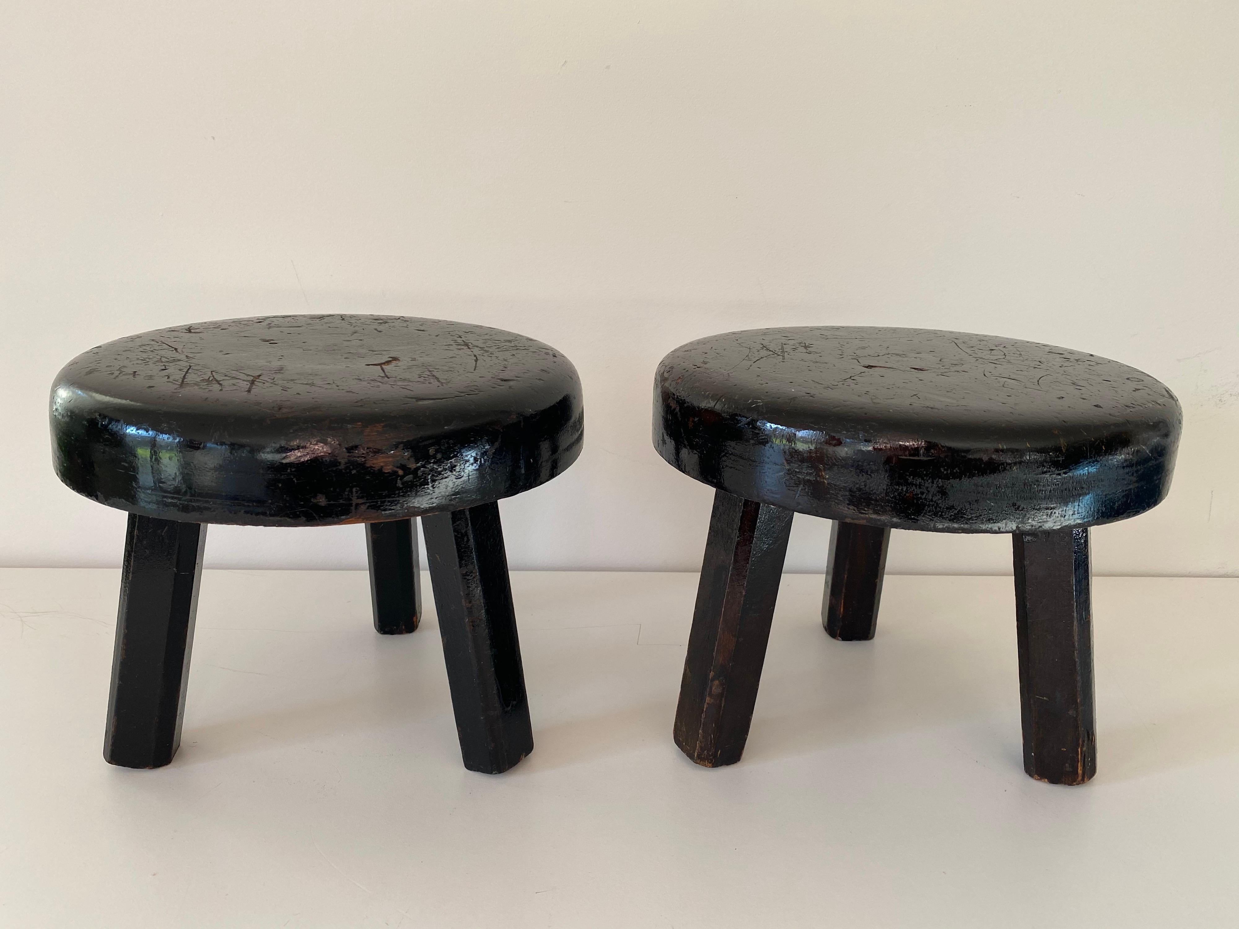 A pair of small midcentury stools with ebonized wood frame.