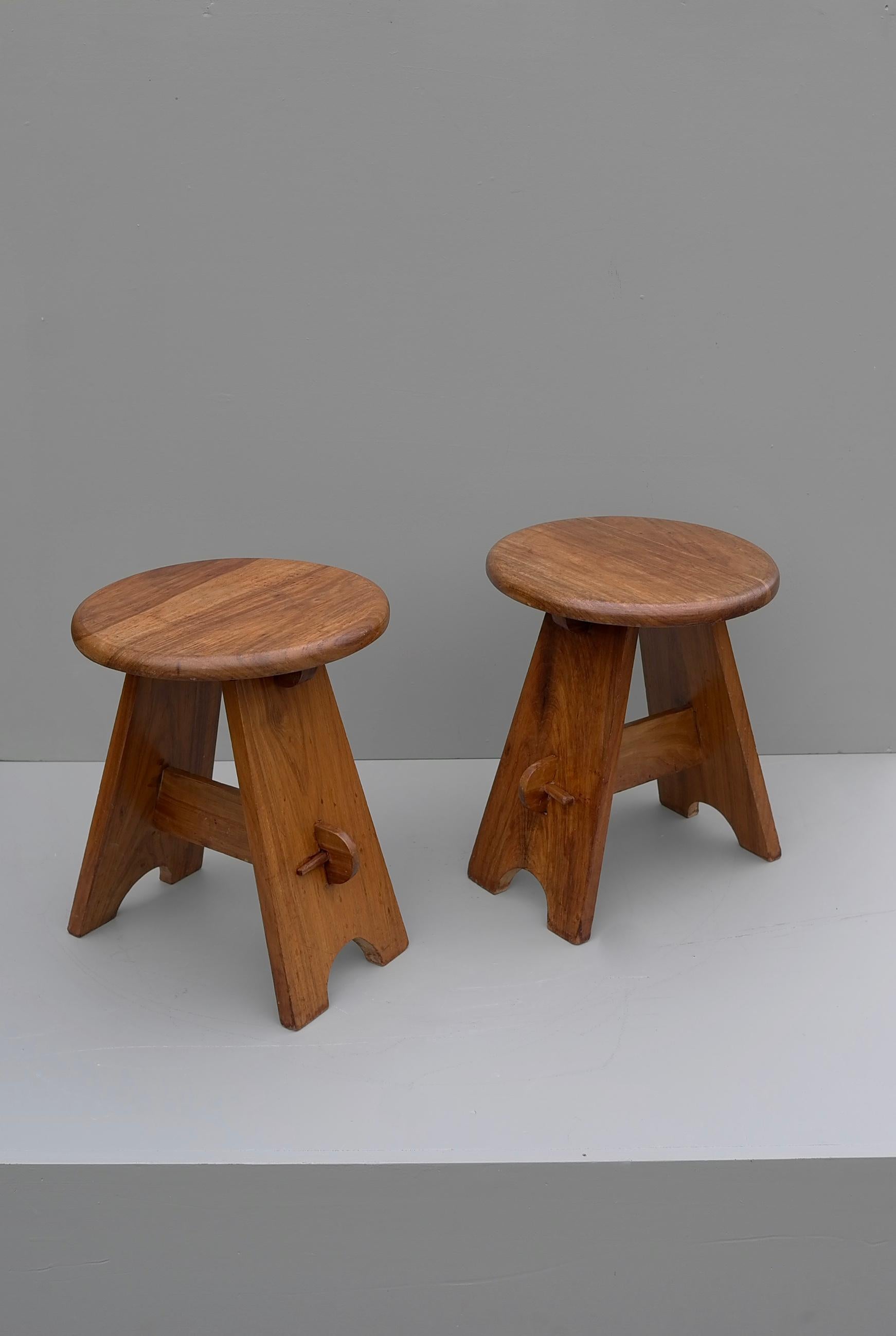 Pair of midcentury stools in solid elmwood, France, 1950s.
