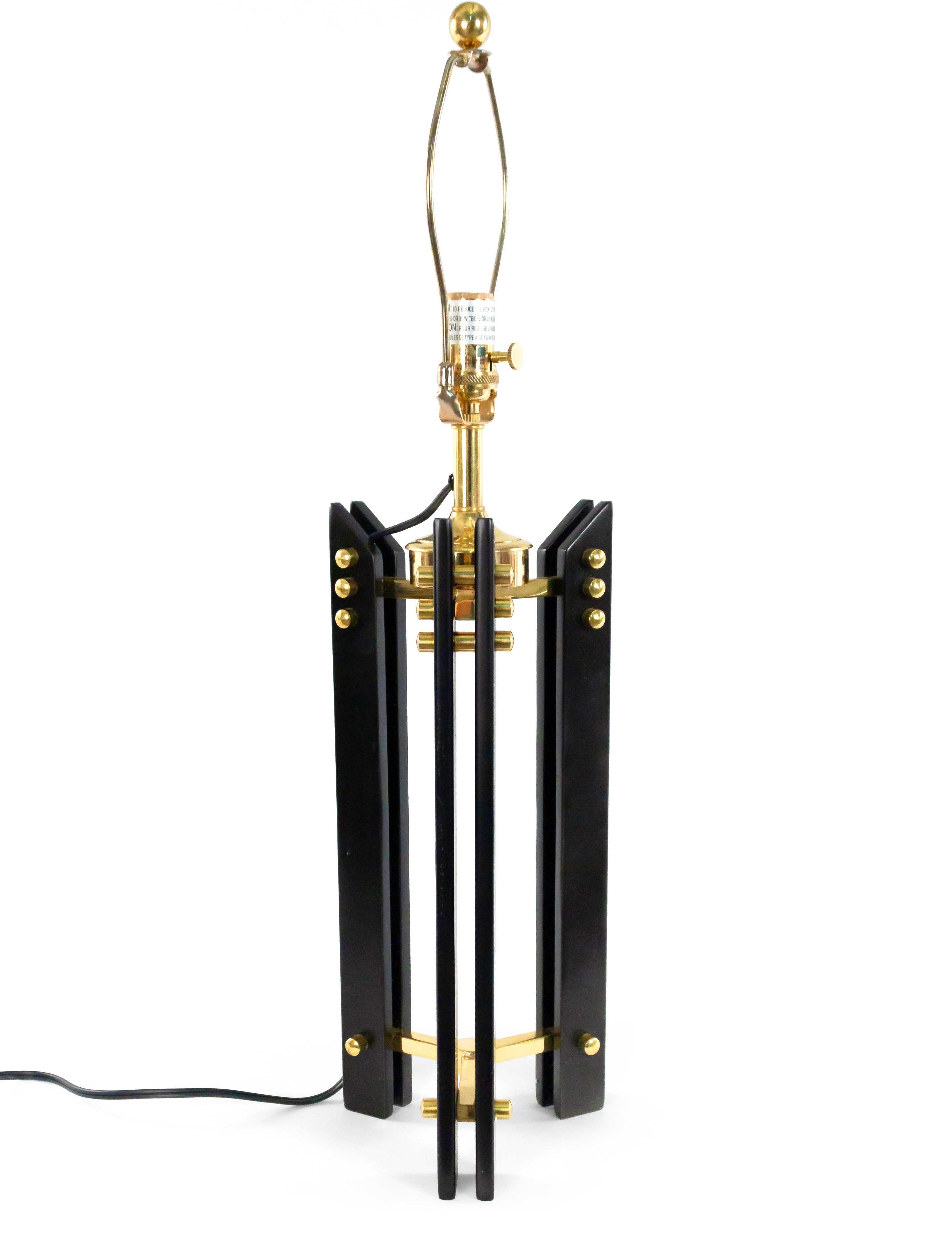 Pair of Mid-Century style black and gold-toned linear tripod table lamps with brass hardware and included harps (PRICED AS PAIR).