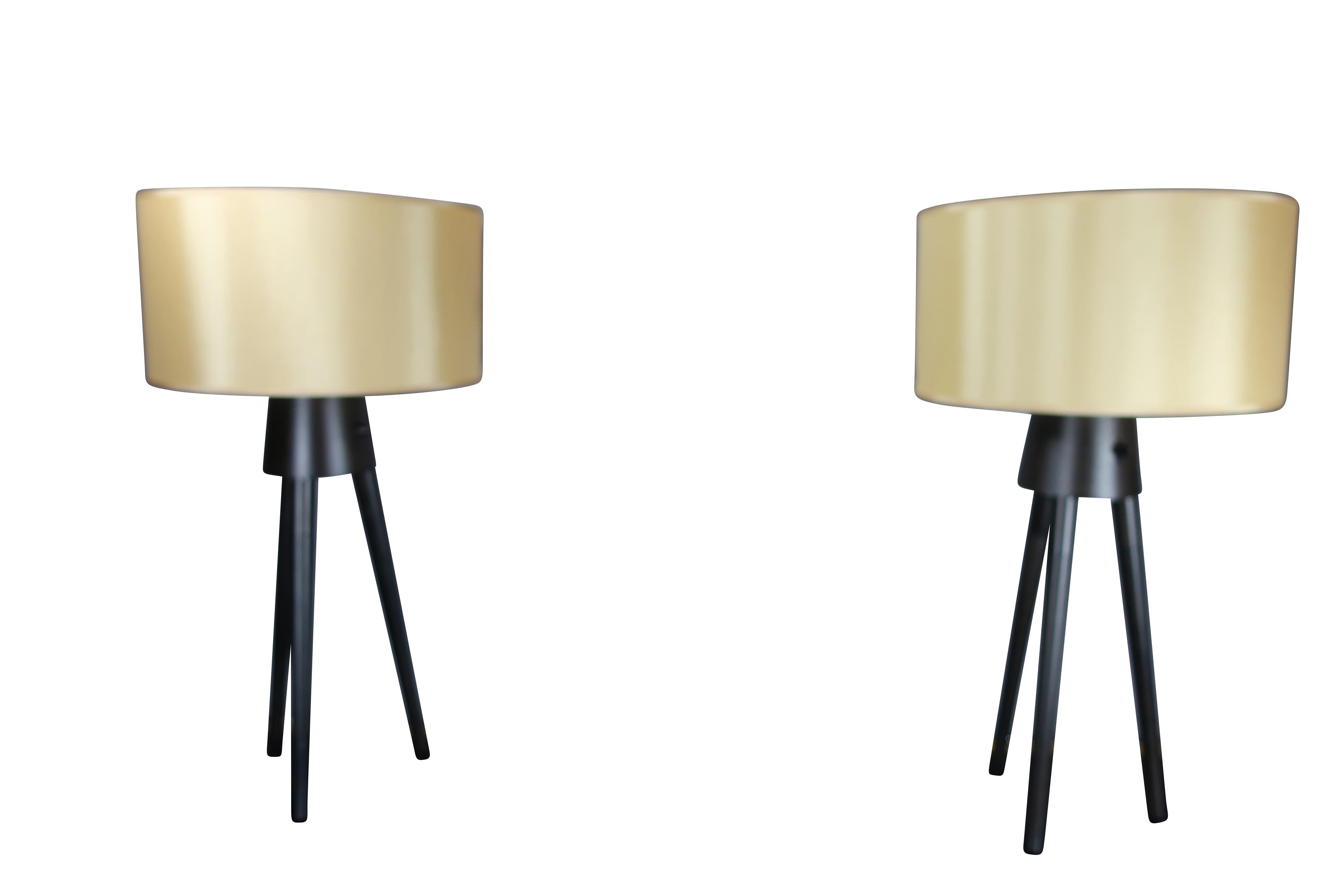 Contemporary Pair of Midcentury Style Black Tripod Lamps with Champagne Shades For Sale