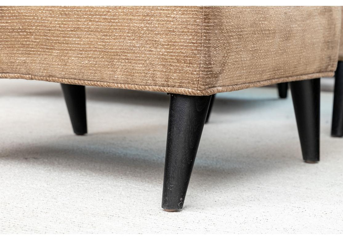 Paire de fauteuils club sur mesure avec accoudoirs inhabituels en forme de poignées, détails du dossier touffeté horizontalement, dossier fixe, avec coussin d'accentuation contrastant et reposant sur des pieds cylindriques effilés. Livré avec un