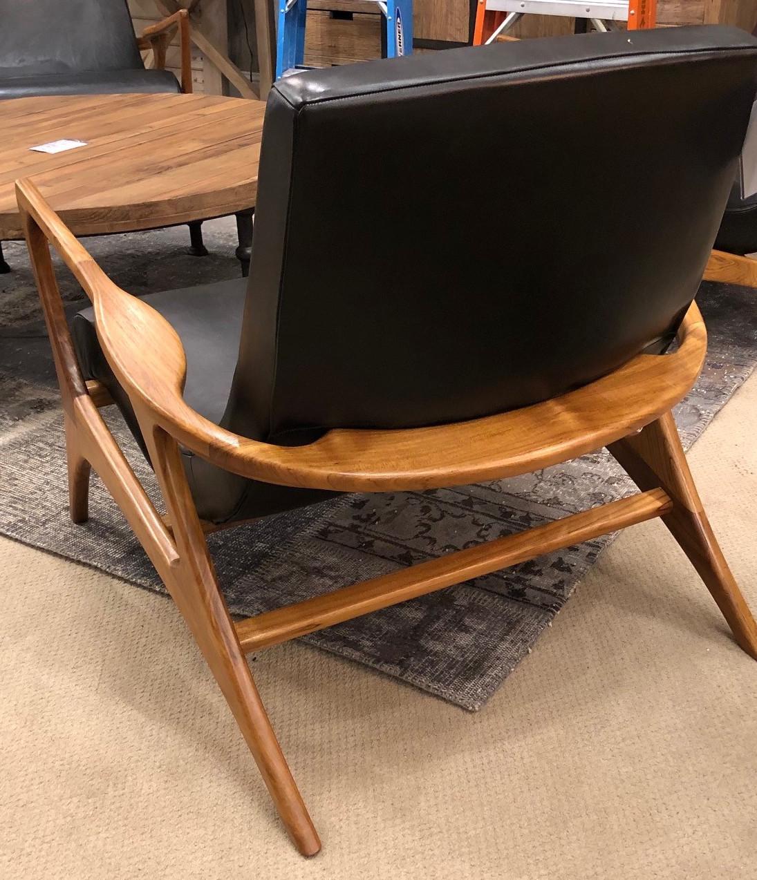 One pair of midcentury style teak and leather club chair, great scale for comfort. Great application for contract use.  Four available, priced per chair.
 