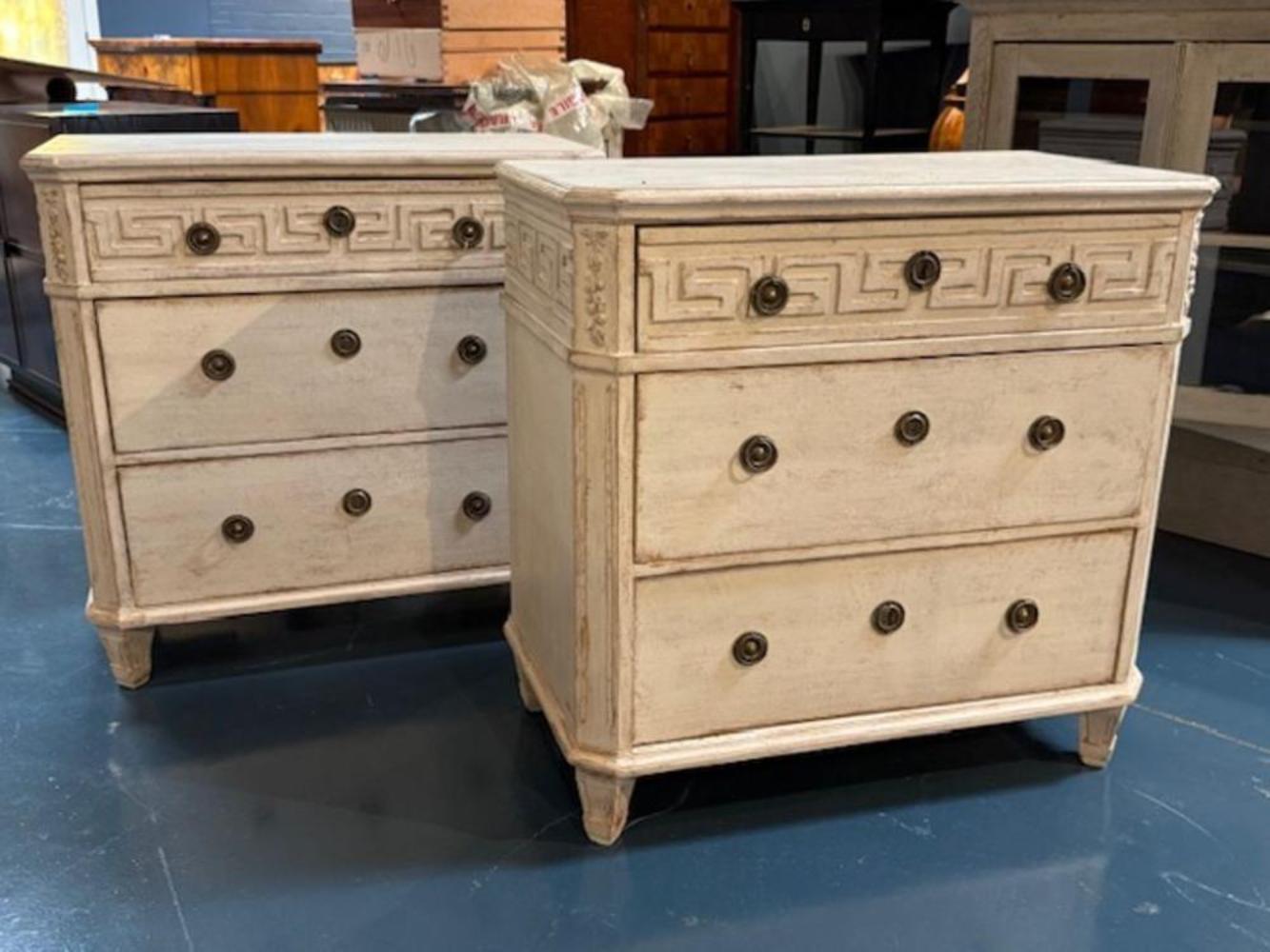 Discover the charm of classic Swedish design with this pair of mid-century Gustavian chests. Each piece boasts a Greek Key design carving that add a touch of elegance and character to your decor. Elevate your home with these exquisite pieces of
