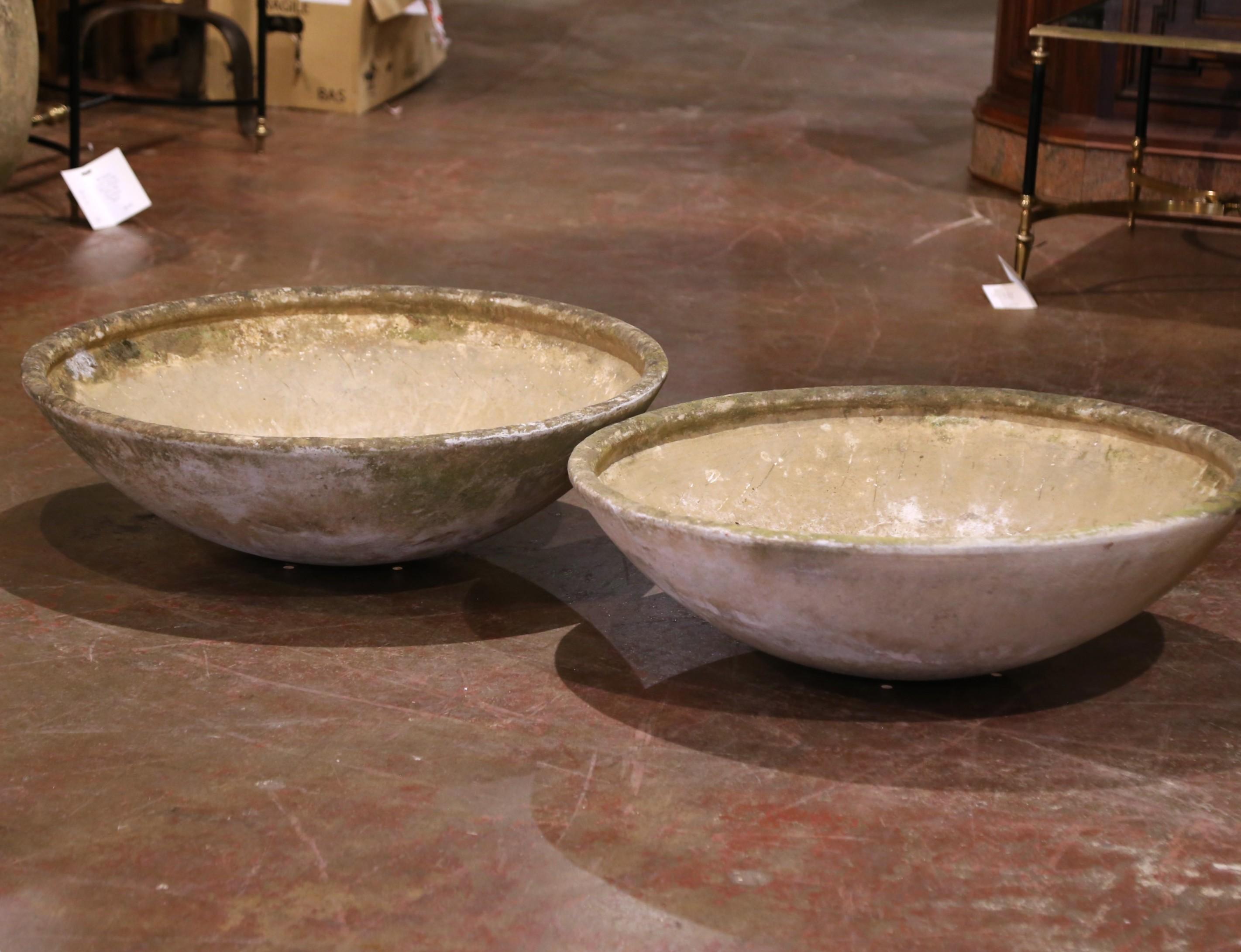 This sculptural pair of shallow concrete planters was designed by Swiss modernist Willy Guhl for Eternit and dates to circa 1950. Each piece is formed in Guhl’s iconic wide saucer shape, cast from fiber-cement, a durable, weather-resistant material