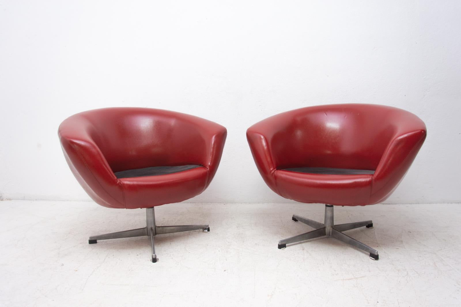 A pair of 1970s swivel chairs manufactured by the famous UP Zavody company. This type of chairs is characterized by their innovative molded expanded construction which provide an extremely lightweight and durable design. The iconic chair features a
