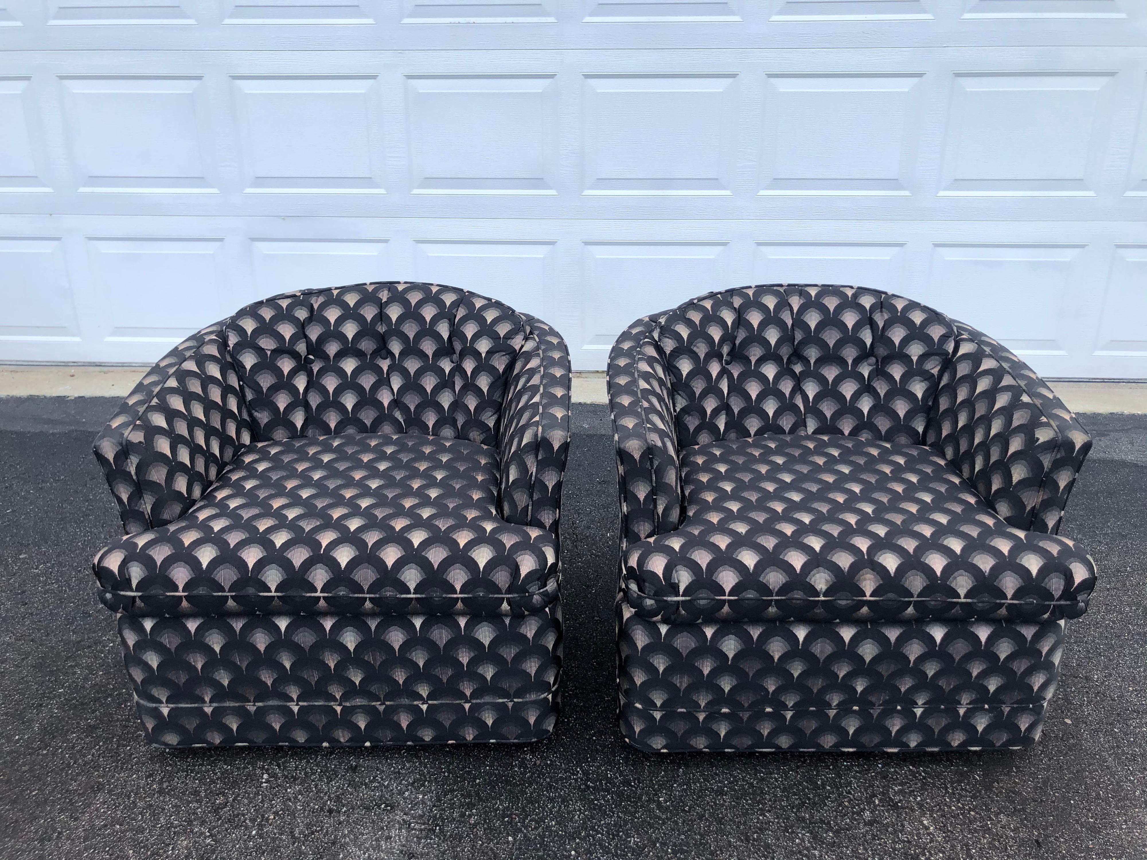 Pair of Mid Century swivel club chairs. Art Deco designed upholstery with black , gray and white arched rainbow shape. Solid heavy construction. Very durable original upholstery. Seat width is 20-21