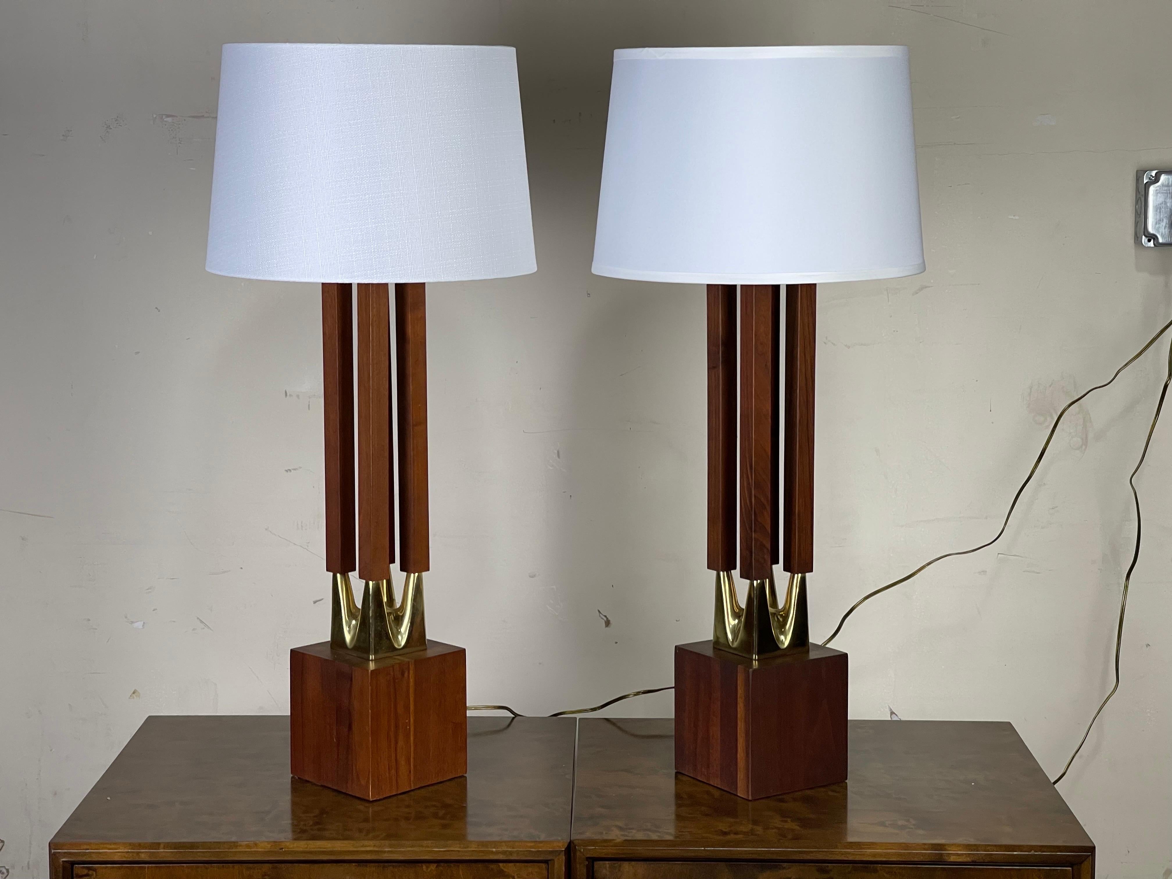 Striking large midcentury columned walnut and brass table lamps by Laurel Lamp Co. Some light spotting/oxidation to brass. See pictures. 
Measures: Lamps: 33.75