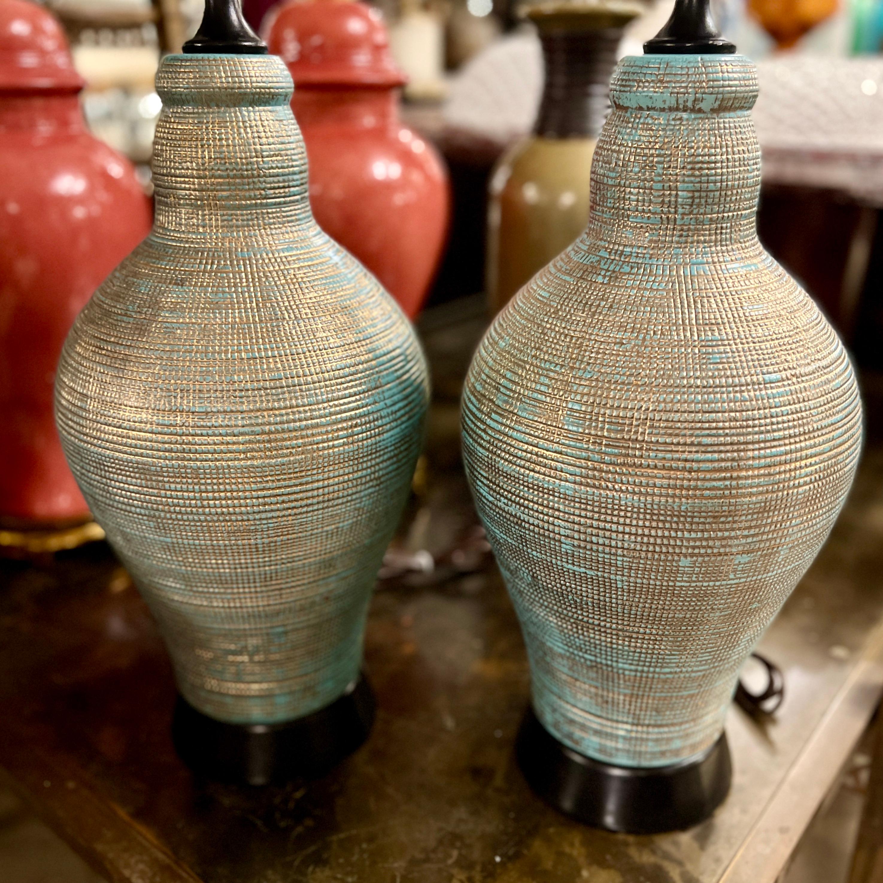 Pair of circa 1960's Danish turquoise and gold  textured porcelain table lamps with lacquered wood bases.

Measurements:
Height of body: 20