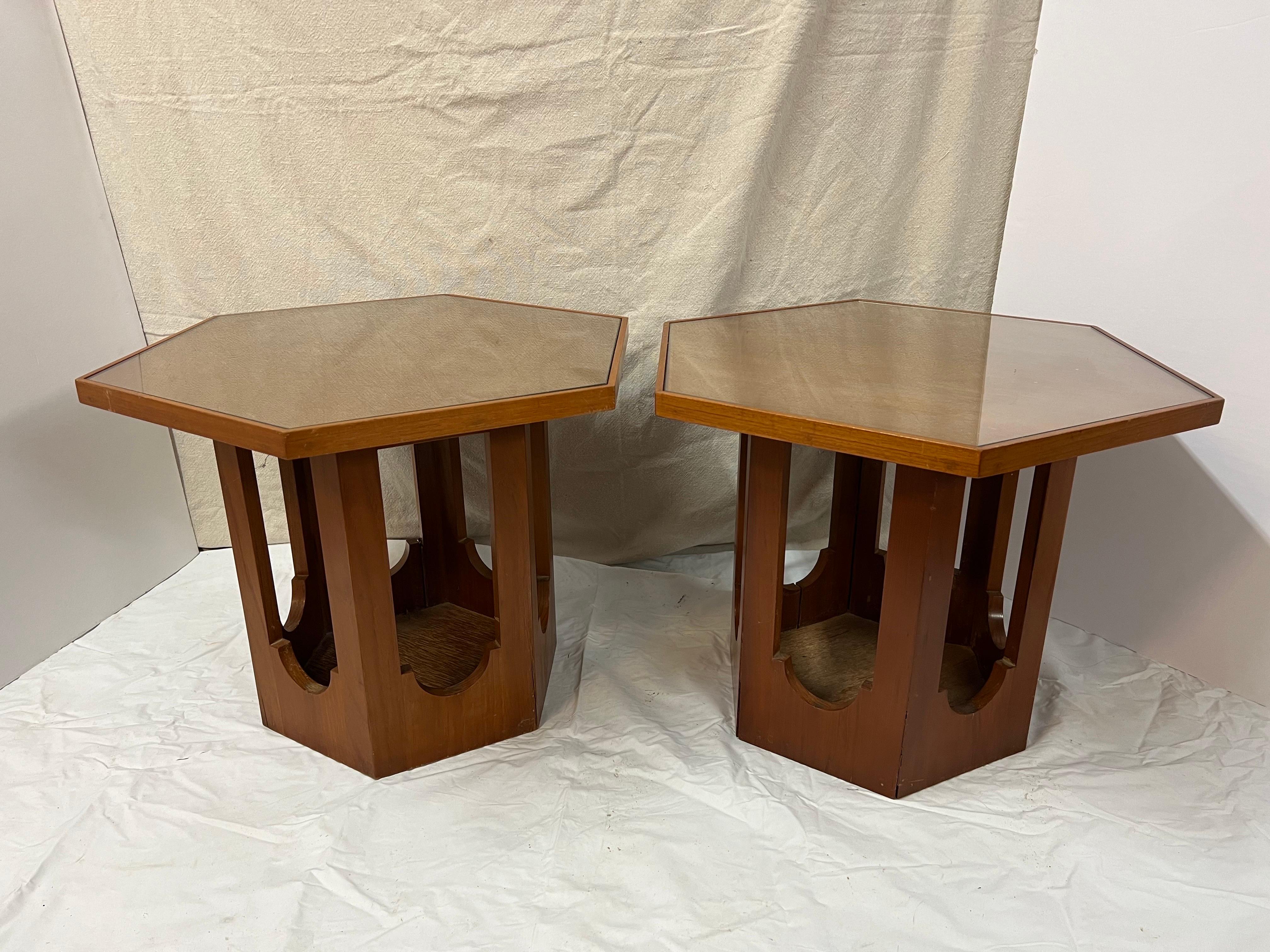 Pair of Mid Century tables by Harvey Probber. Hexagonal in shape with an inlaid glass . Made of Teak Wood. Some separation at some seams . See photos. These can parcel ship domestically much more economically than white glove.