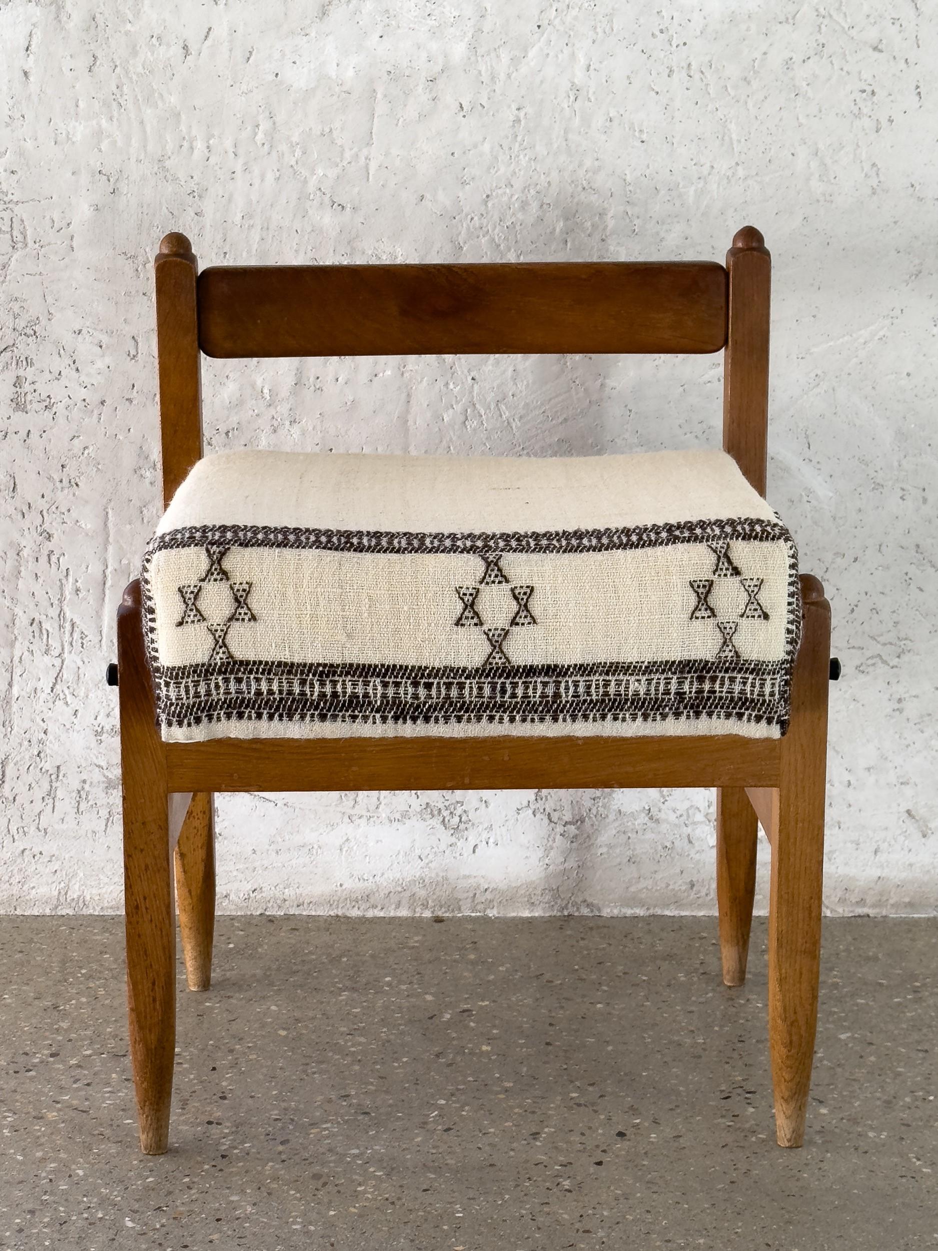 A truly unique pair of midcentury French chairs designed by GUILHERME AND CHAMBRON and expertly reupholstered in vintage African fabric. 