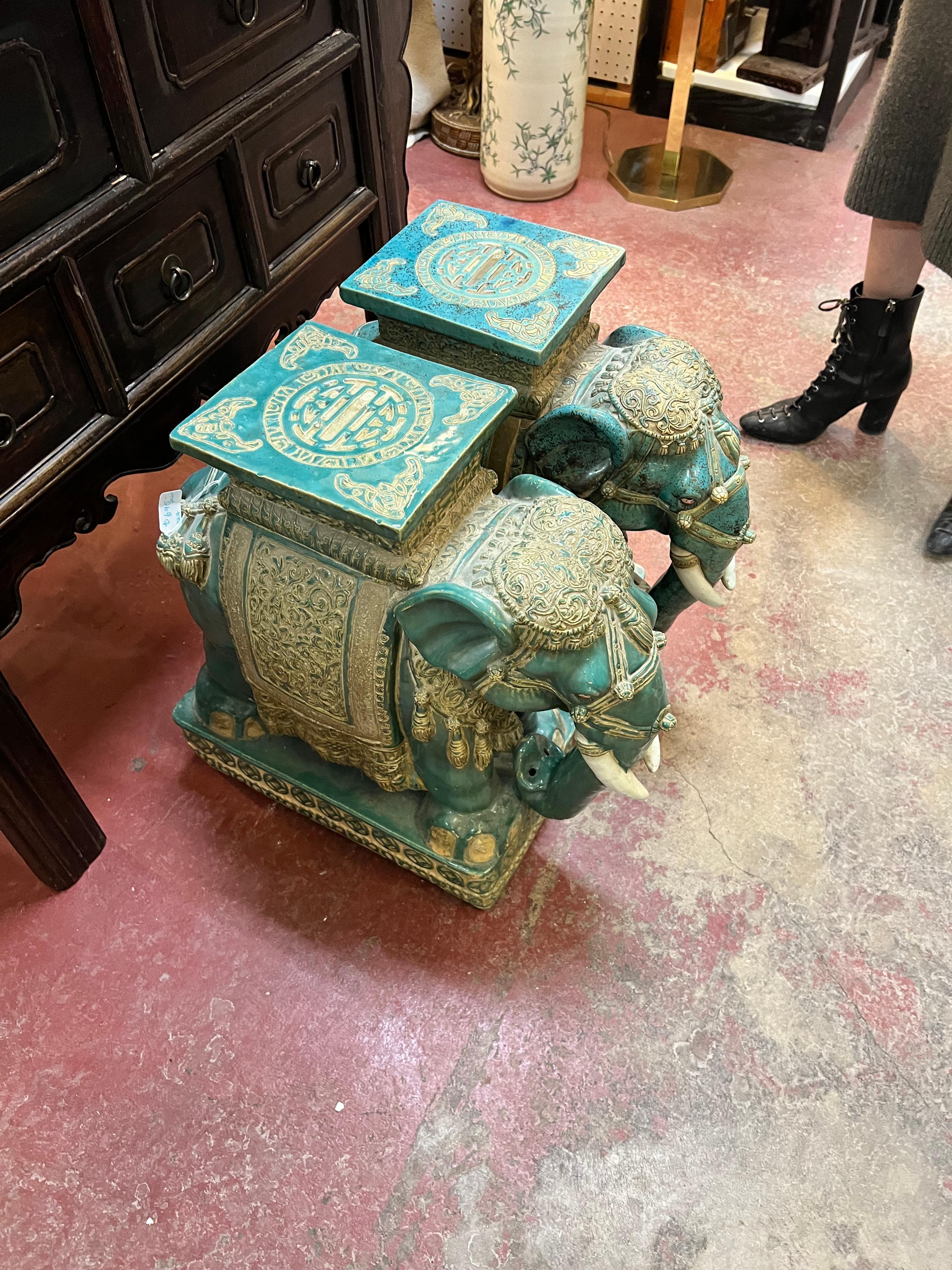 Unusual and rare pair of mid century elephants. Richly patinated in greens and gold, these twin sentries will elevate your gazebo, garden or orangerie. This green blue is a 'lost' color bringing old world charm and eloquence to any space they