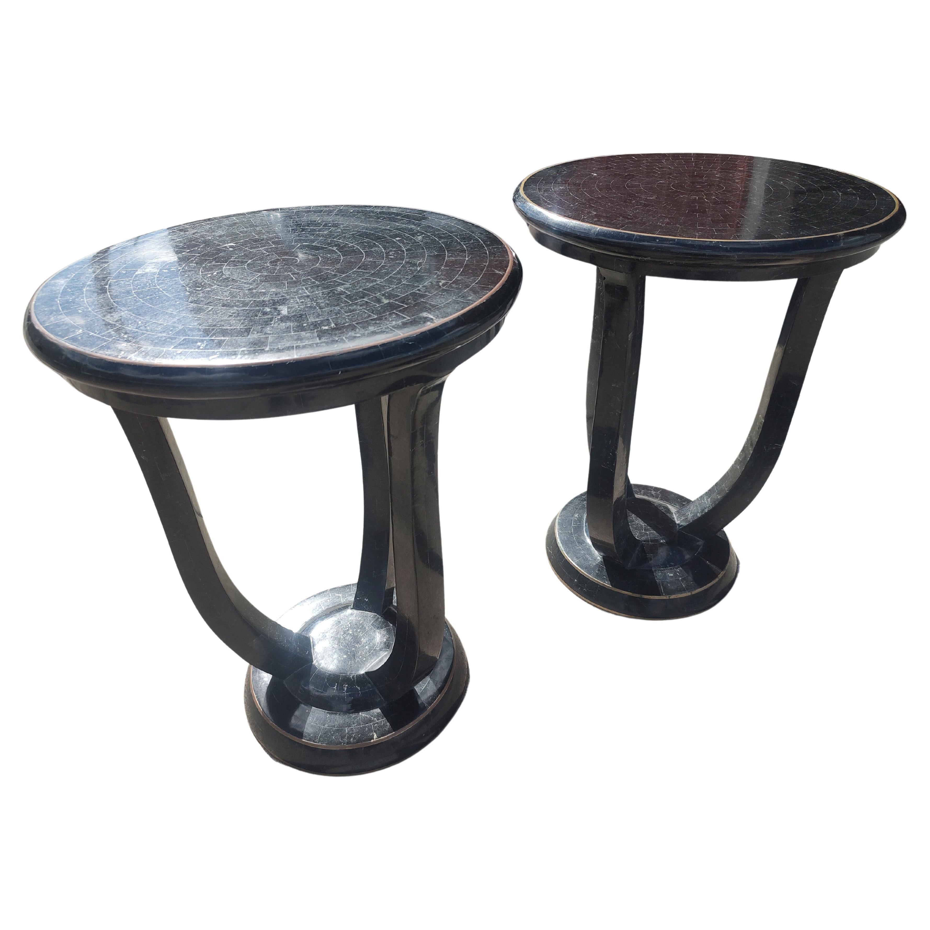 Fantastic pair of Tessellated Stone marble in Black completely encompassing the entire table, base legs and the top. Expertly crafted and meticulously placed fitting exactly as planned. Bronze rings on base and top give a soft tone contrasting with
