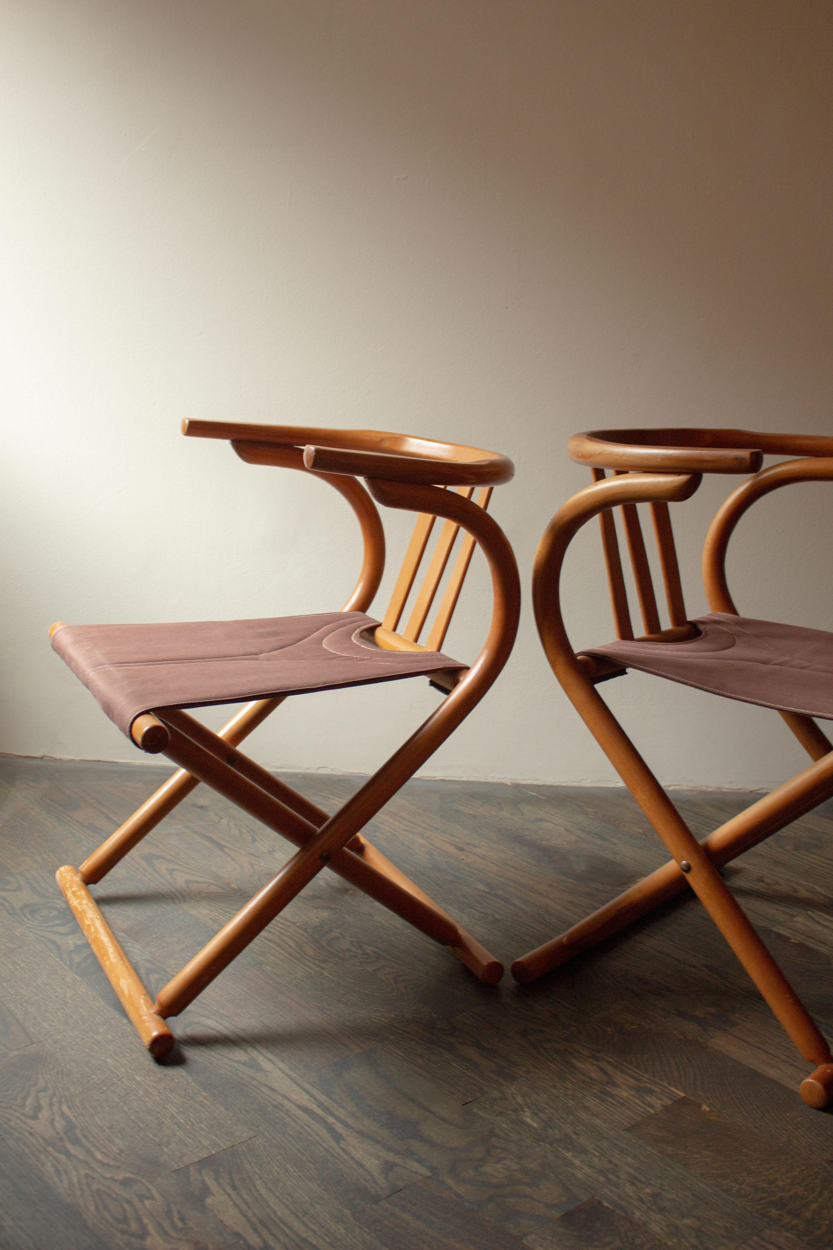 A unique pair of chairs with a heavy Thonet influence. From the bentwood, the lines and curves, the sleekness, the fluidity. Classic yet so unusual. Canvas and wood are in great condition.