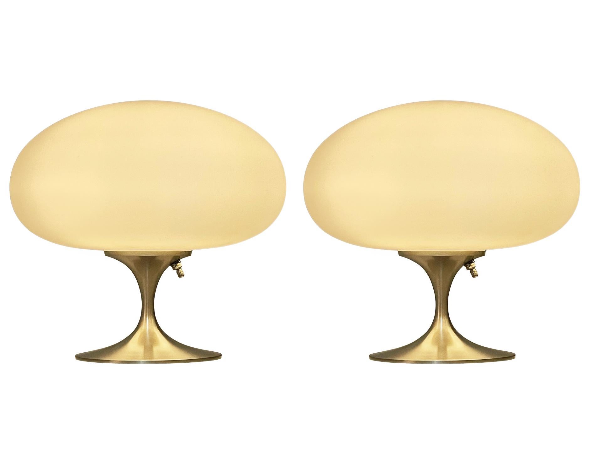 A gorgeous matching pair of tulip form table lamps after Laurel Lamp Company These feature nickel plated cast aluminum bases with mouth blown frosted white glass shades. The price includes the pair as shown.