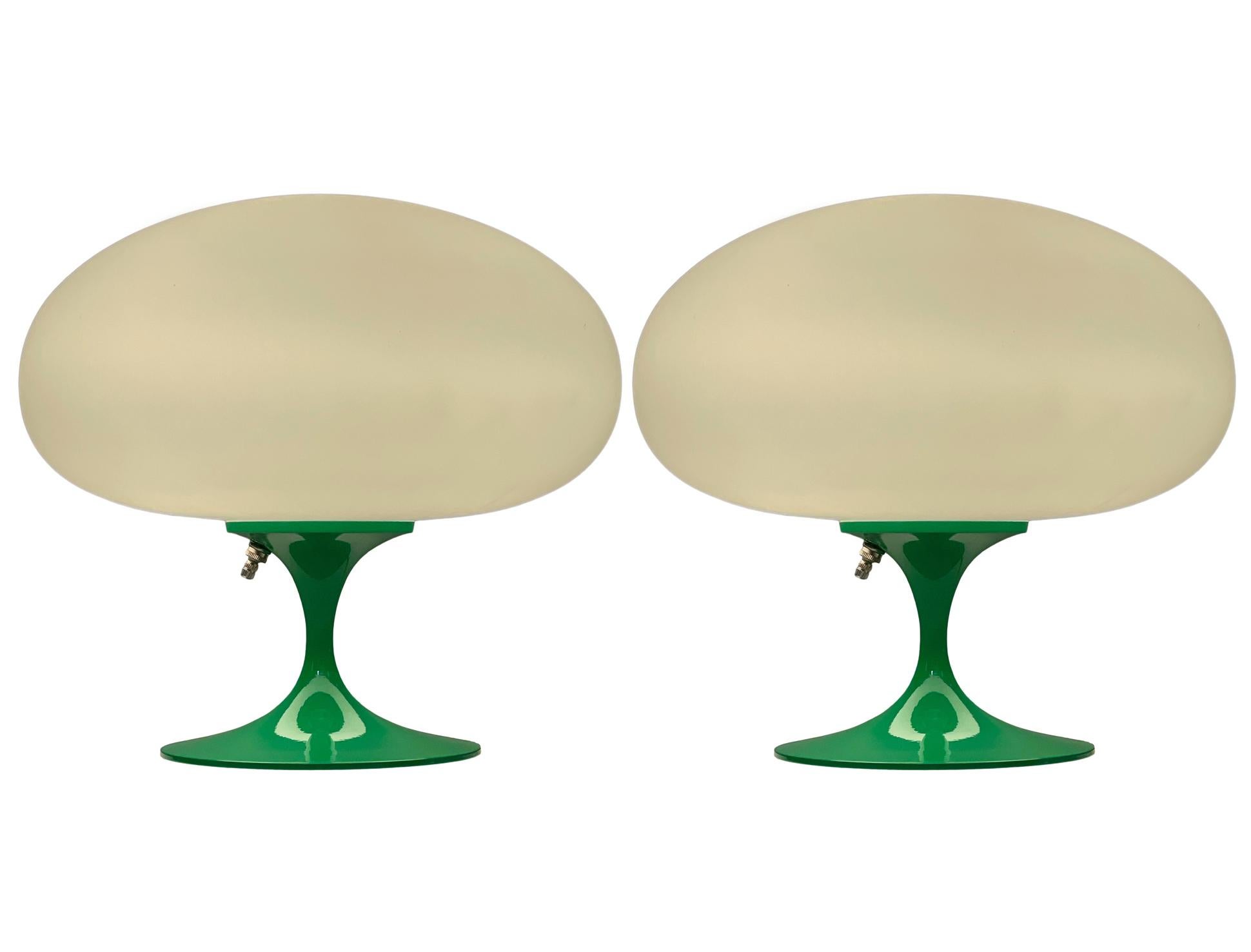 A gorgeous matching pair of tulip form table lamps after Laurel Lamp Company These feature green powder coated cast aluminum bases with mouth blown frosted white glass shades. The price includes the pair as shown.