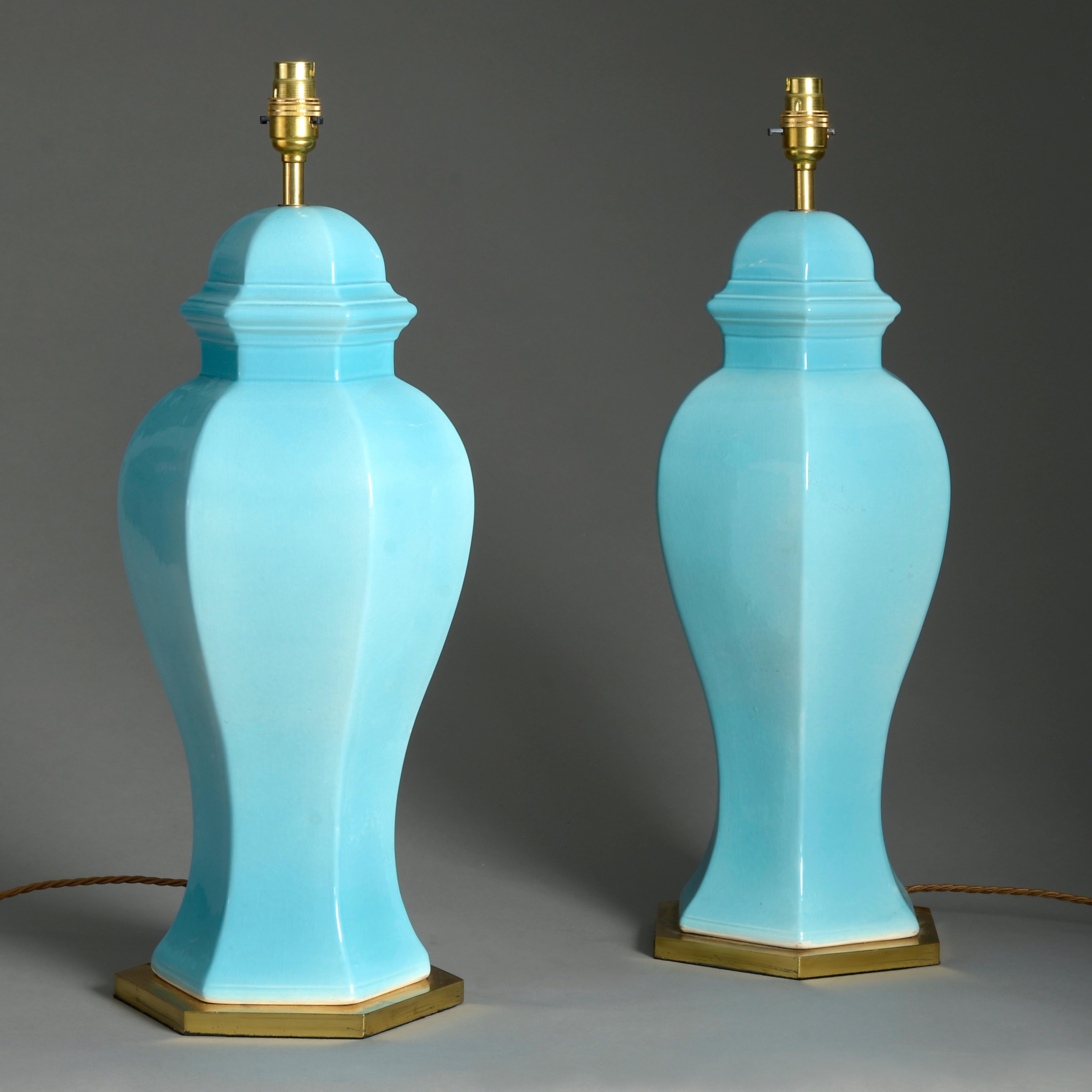 A pair of mid-20th century turquoise glazed ceramic vases, of hexagonal baluster form and set upon gilt brass bases.

Shades available to purchase separately.