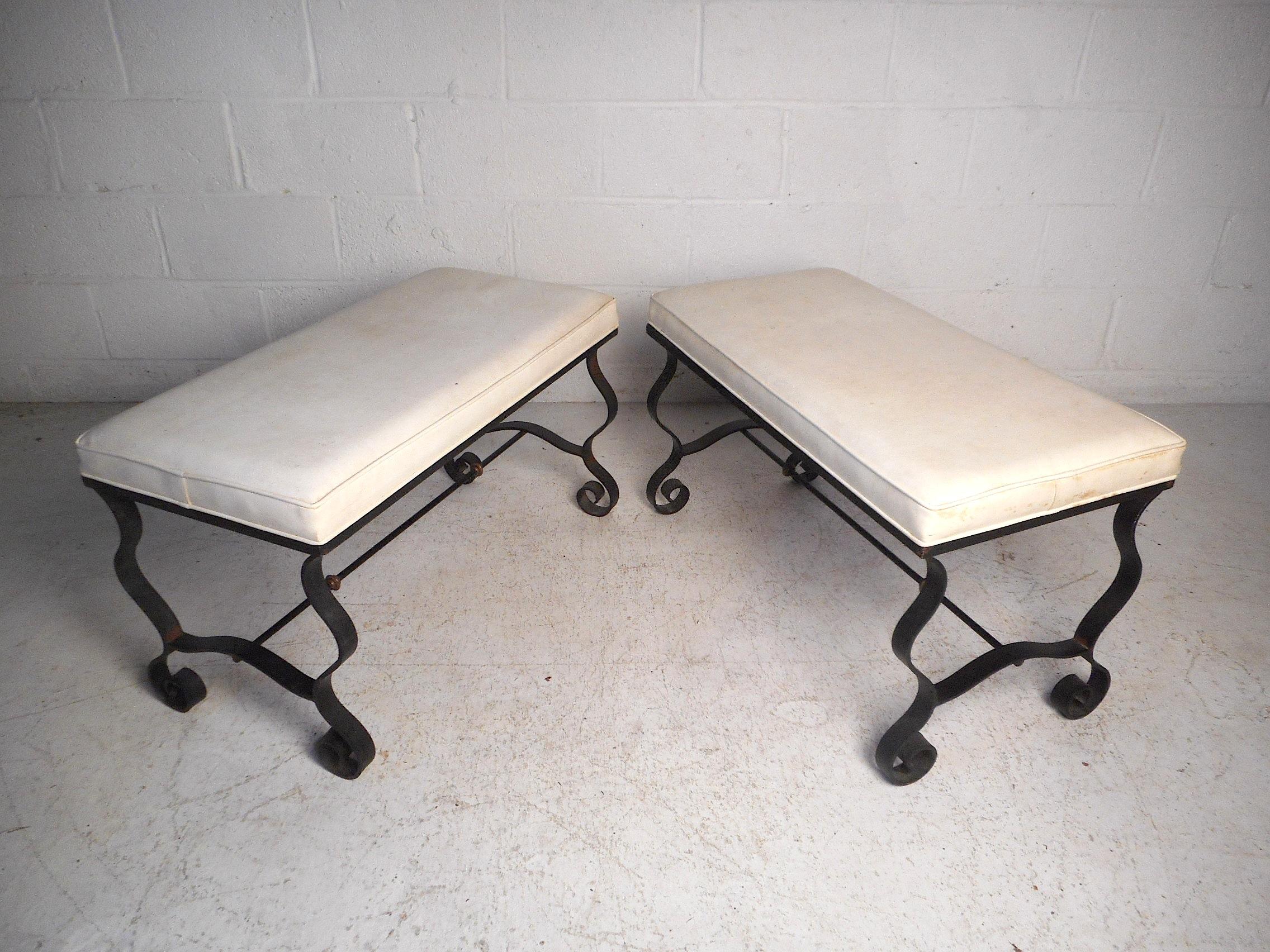 This impressive pair of midcentury benches feature sturdy and ornate iron frames, comfortable seating, and a white faux-leather upholstery. This pair would make a great addition to any modern interior. Please confirm item location with dealer (NJ or