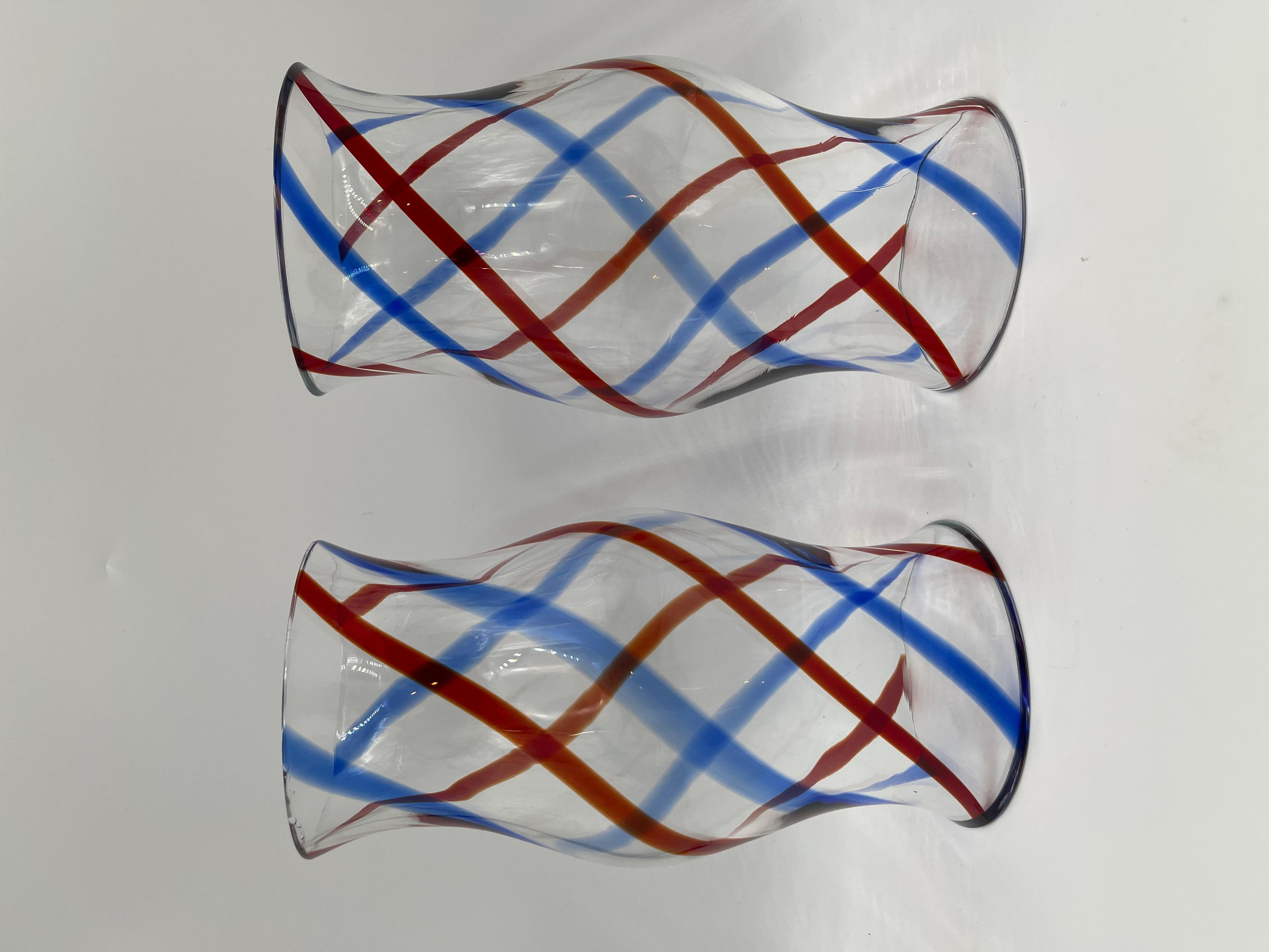 Pair of striking mid-century Venetian glass hurricane shades. Baluster form with red and blue spiral decoration. A gorgeous addition to any table, sideboard or fireplace mantle. Fresh from a New York City estate.