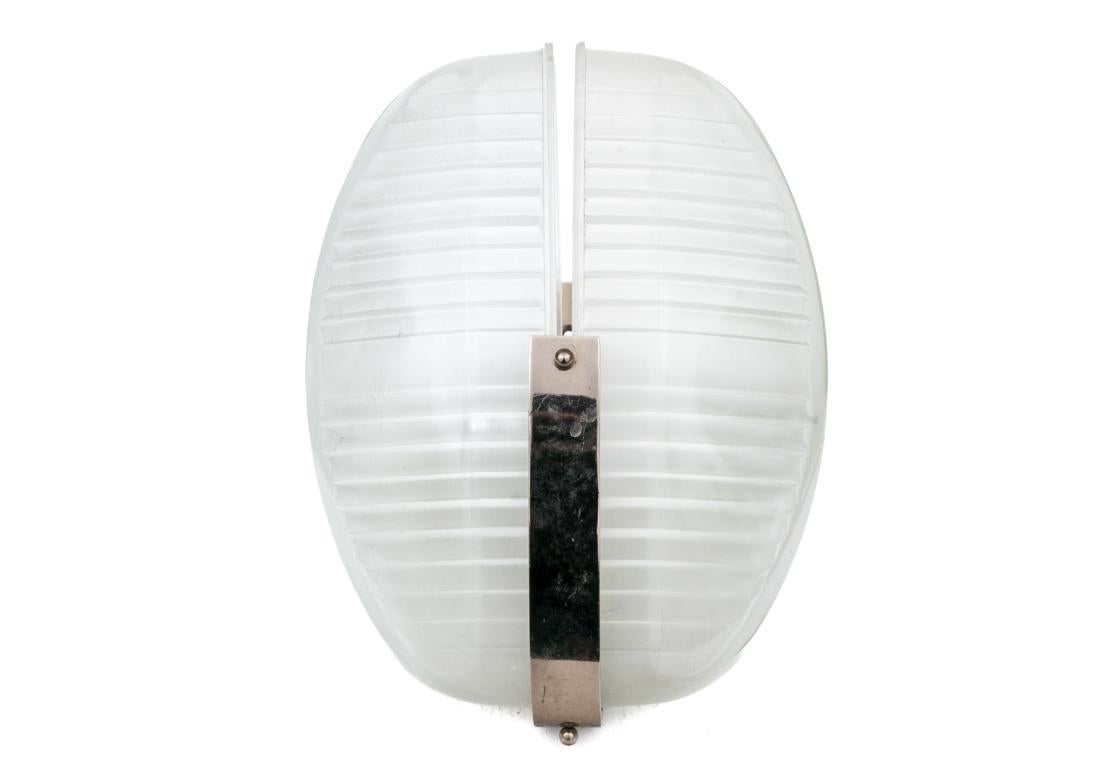 Pair of vintage Lambda wall sconces designed by Vico Magistretti, circa 1961. The wall sconces with two white painted sockets and brackets, two molded glass shades with geometric design, nickel plated steel frames.

Dimensions: 9.5