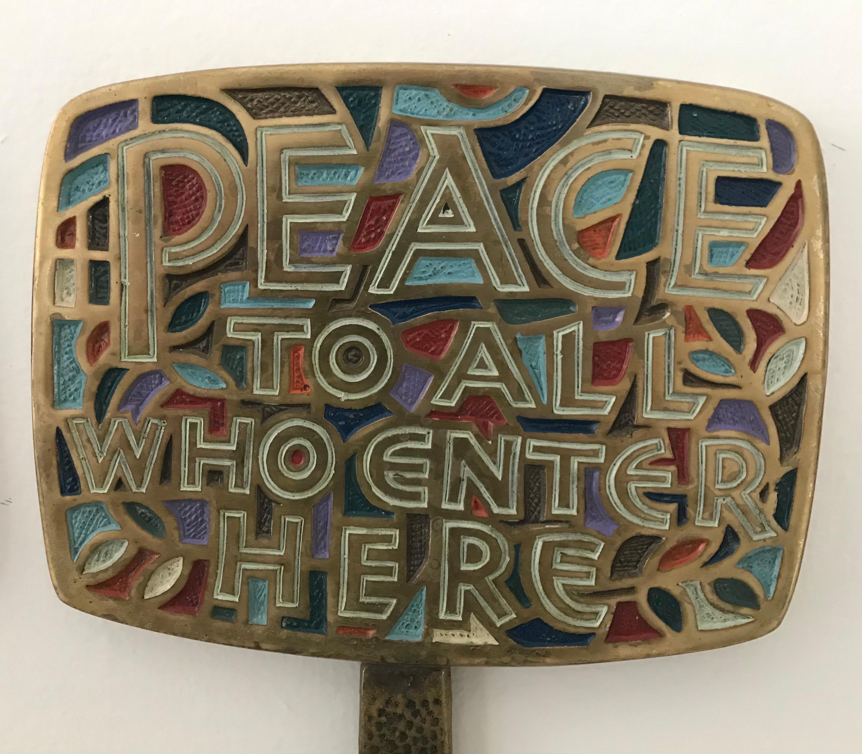 Rare pair of mid-century wall-mounted coat or hat racks, cast metal with colorful enameled lettering 