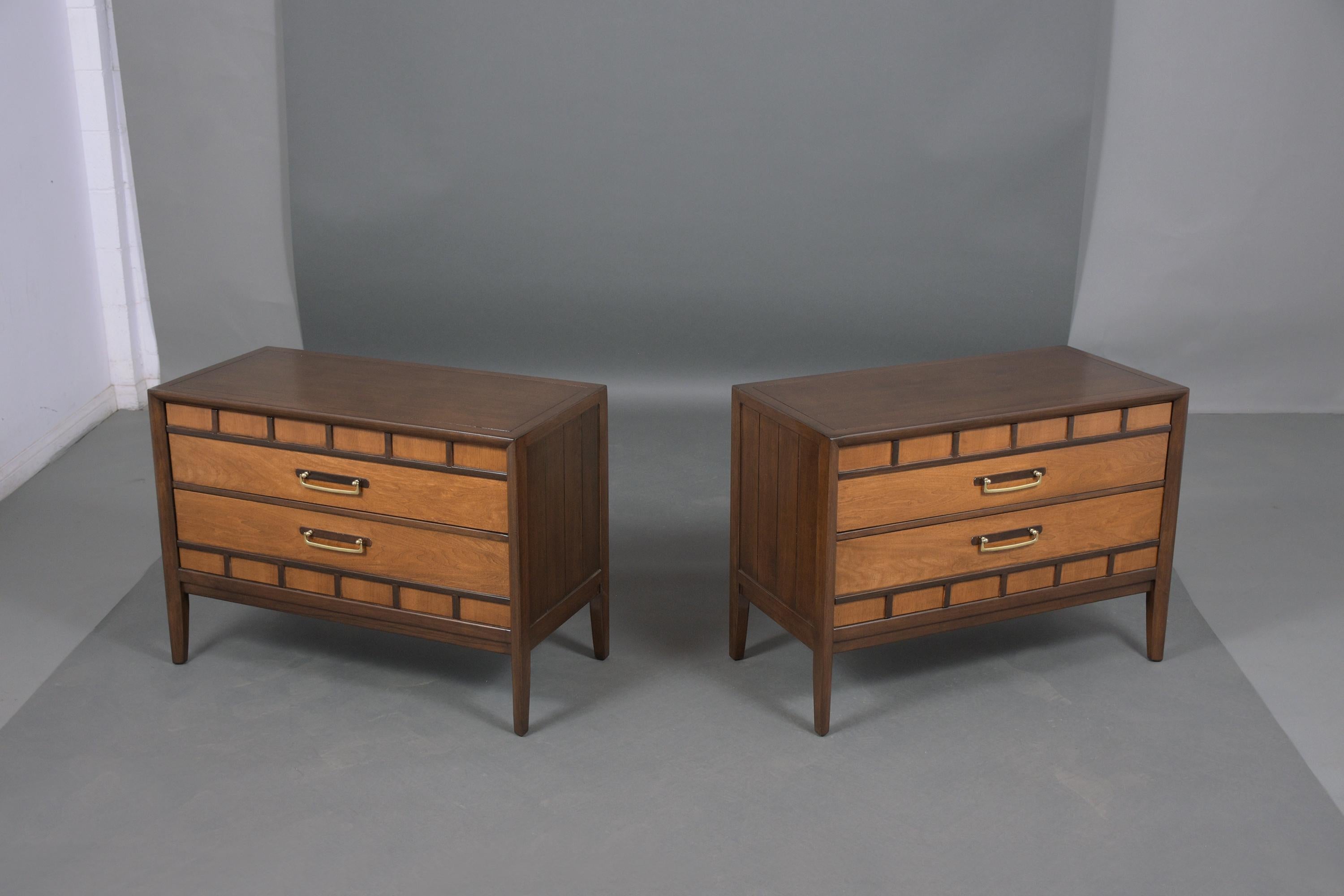 An extraordinary pair Mid-Century Modern dresser has been professionally restored, hand-crafted out of walnut newly stained in dark walnut and Provincial color combination with a lacquer finish. This pair features two drawers brass drop handles,
