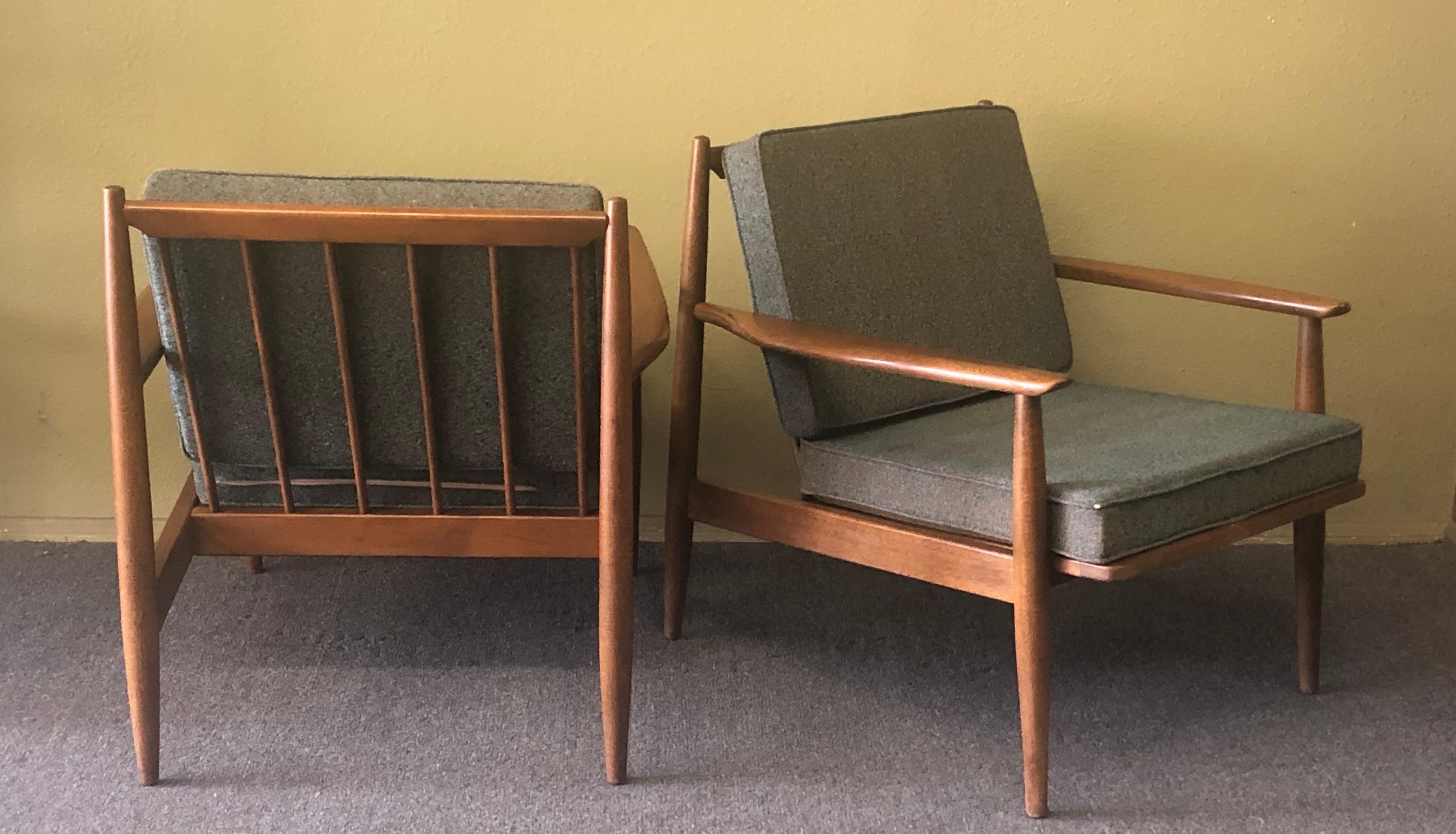 Gorgeous pair of American MCM walnut lounge chairs by Viko Baumritter for Baumritter of New York, circa 1960s. The frames are in excellent condition and are very sturdy and solid. The chairs feature a spindle back, sculpted armrests and dowel legs.