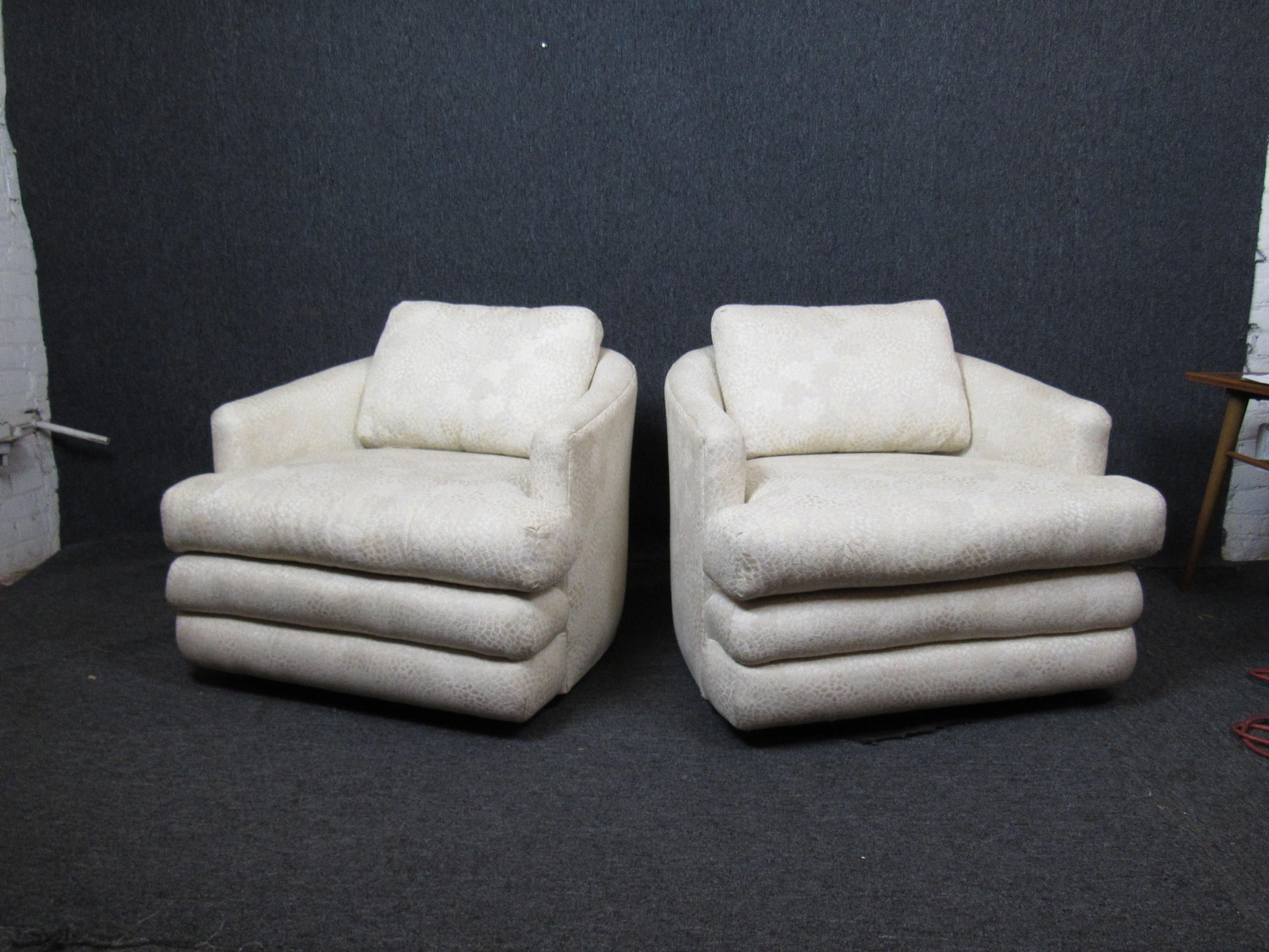 Awesome pair of plush lounge chairs with a funky, snakeskin-like fabric. Oversized, cushy seats sure to provide hours of comfort to you or your guests. Perfect for the home, office, or anywhere in between. Chairs are on casters to make rearranging a