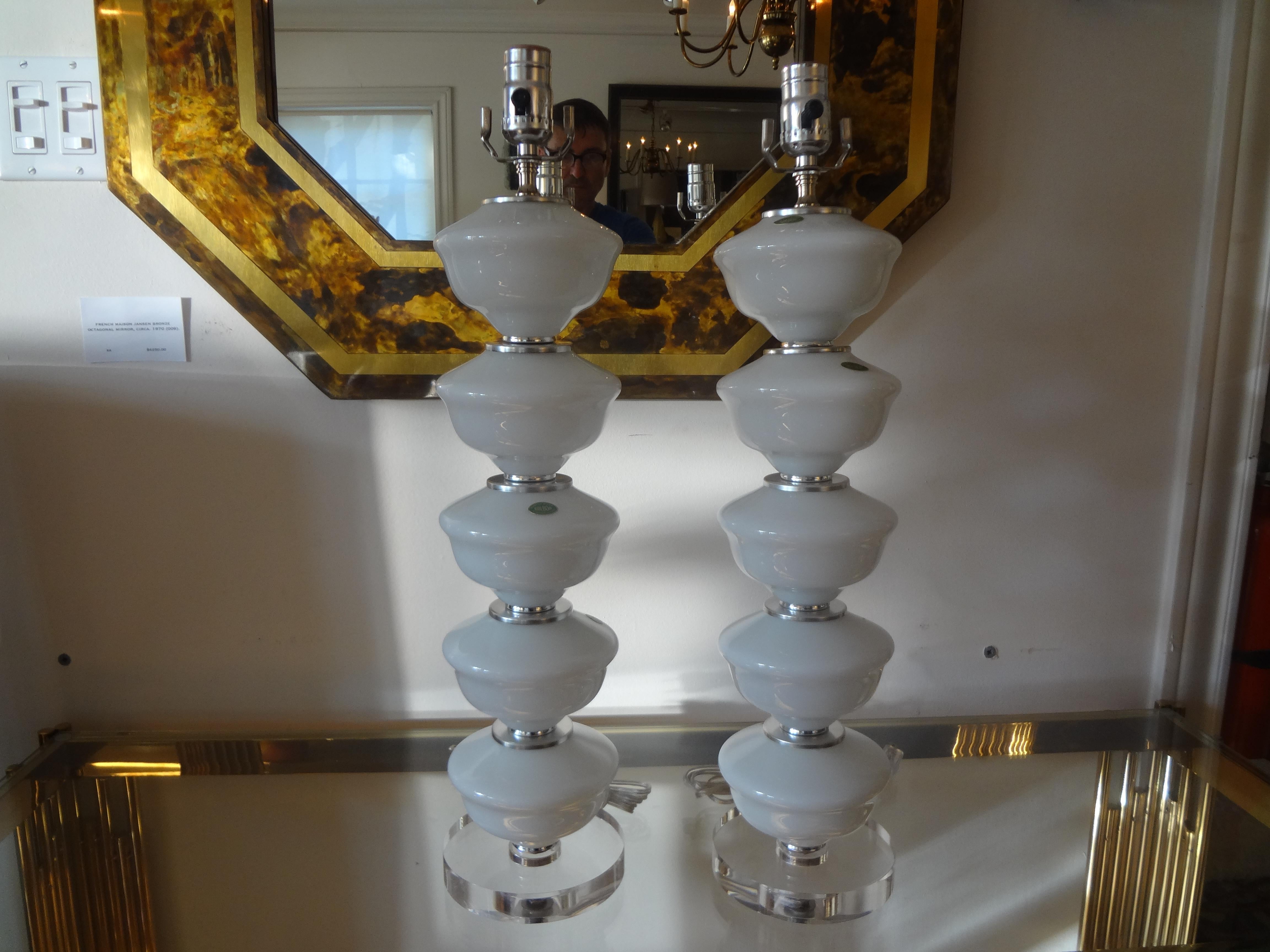 Pair of midcentury white Murano glass lamps.
Stunning pair of midcentury Italian white Murano opaline glass lamps by Balboa. This great pair of Hollywood Regency stacked Murano glass lamps have new lucite bases. Featured blown Murano lamps and are