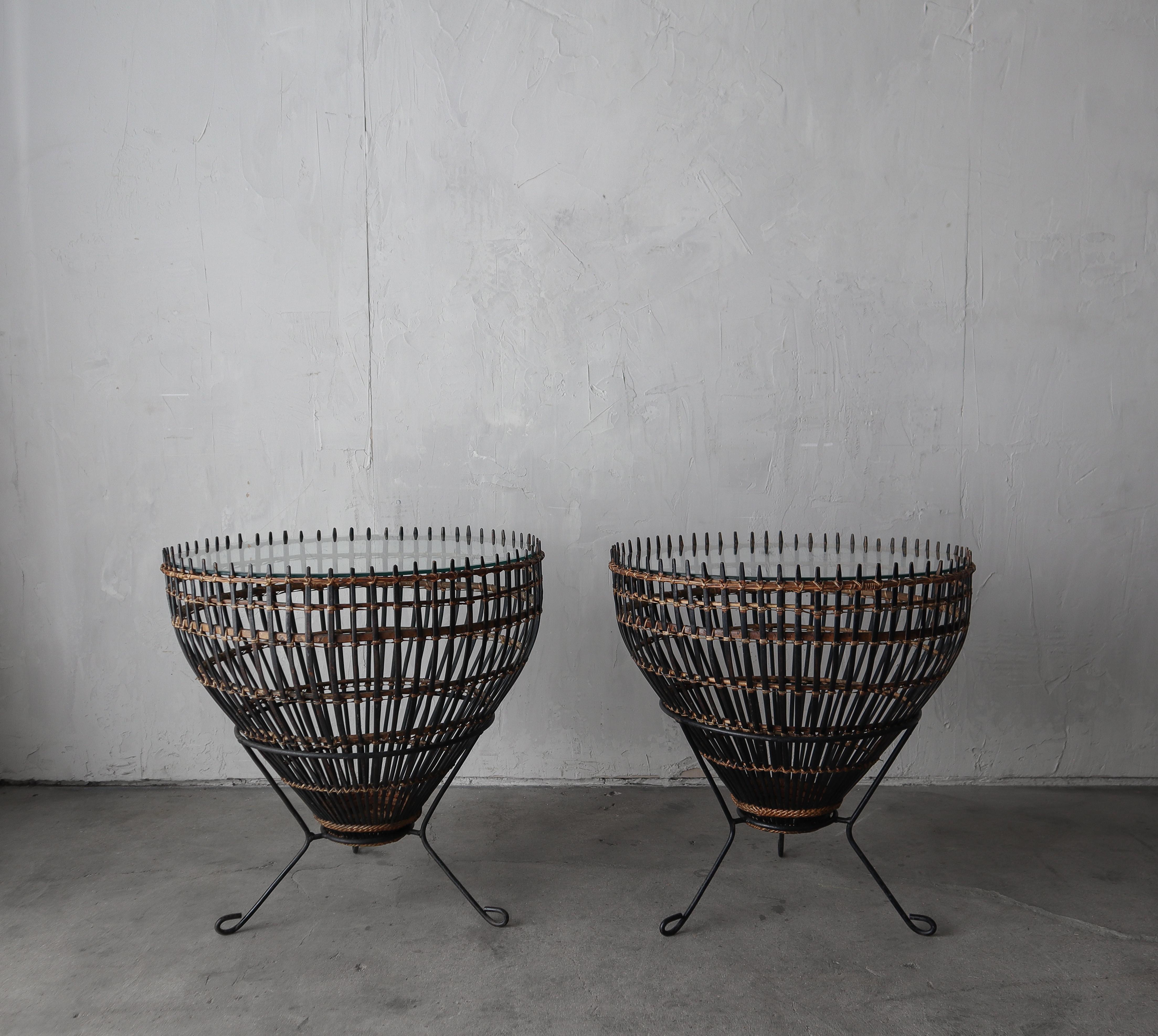 Unique pair of Franco Albini side tables made from wicker fishing baskets placed on iron bases with glass tops.

Both tables measure 23.5