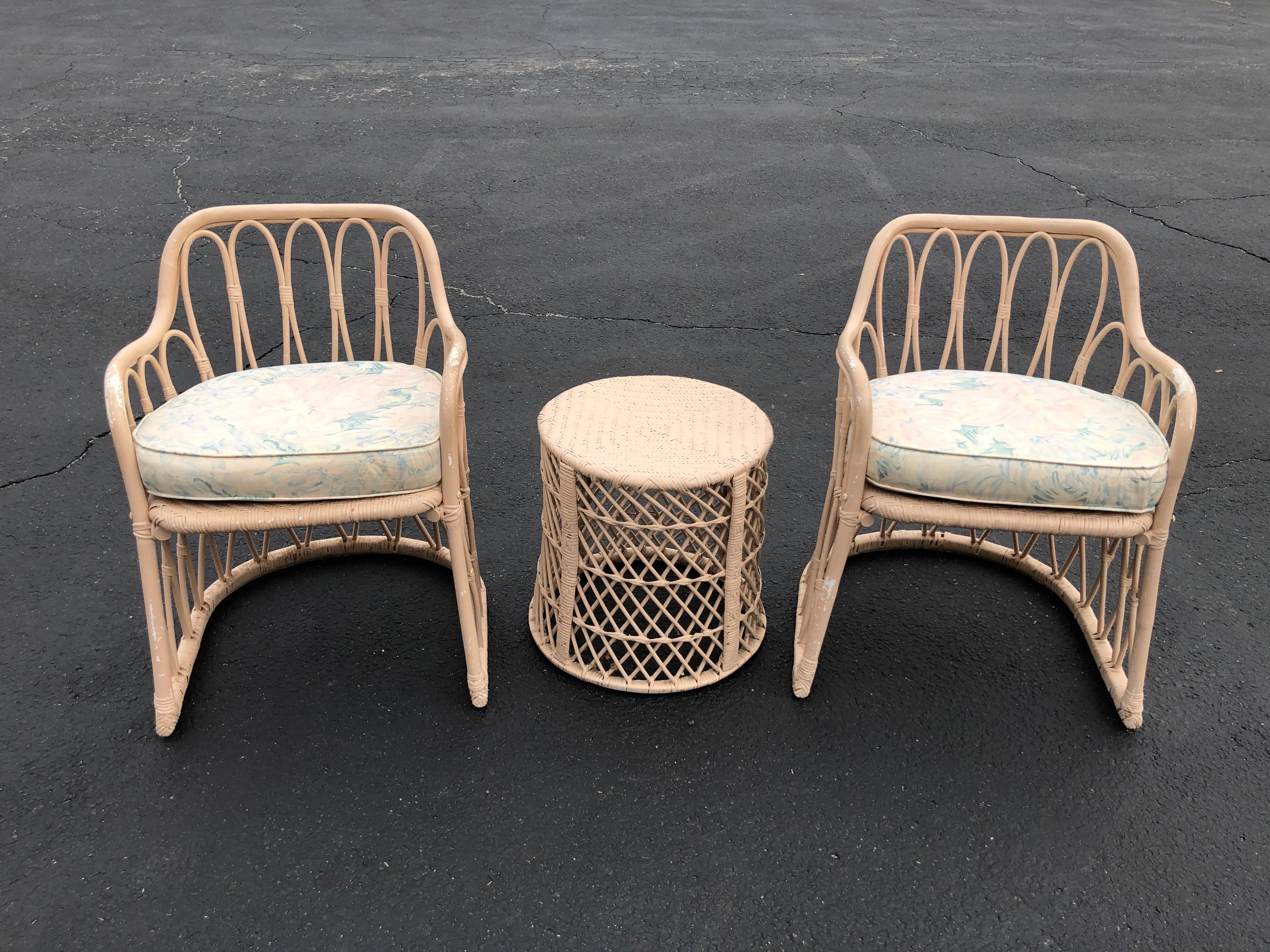 Pair of Mid Century wicker chairs with matching table. Painted a soft pink mauve. Can be resprayed any color.Perfect for an indoor porch. Comes with custom made floral cushions. Fabulous boho chic style.
Table width is 16.75