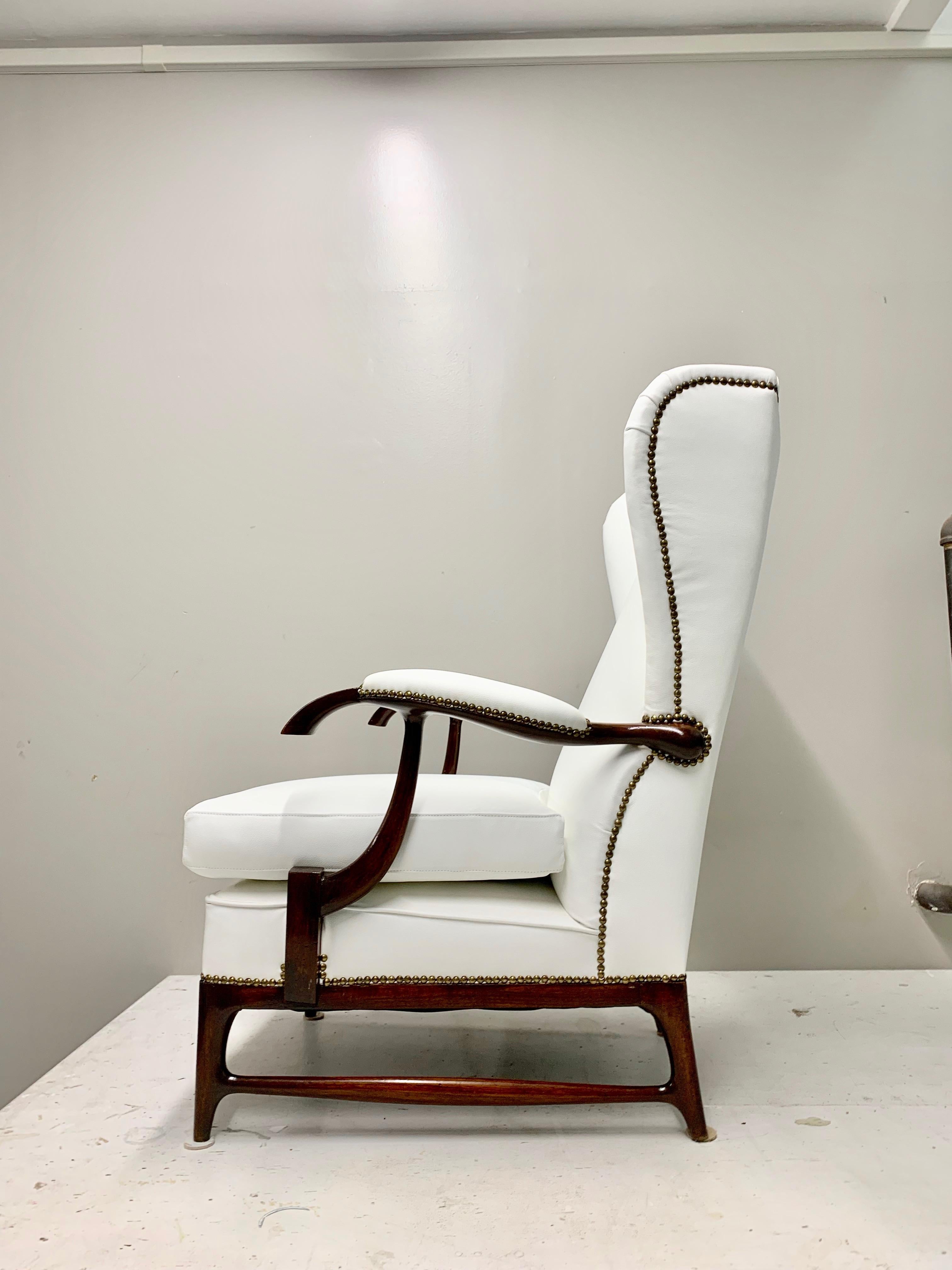 Pair of Mid-Century Wingback Arm Chairs, by Paolo Buffa with a dark wood structure, dated back from the 1960s  with a wingback style. The chairs have completely been restored and re-upholstered with white leather for a striking contrast effect with