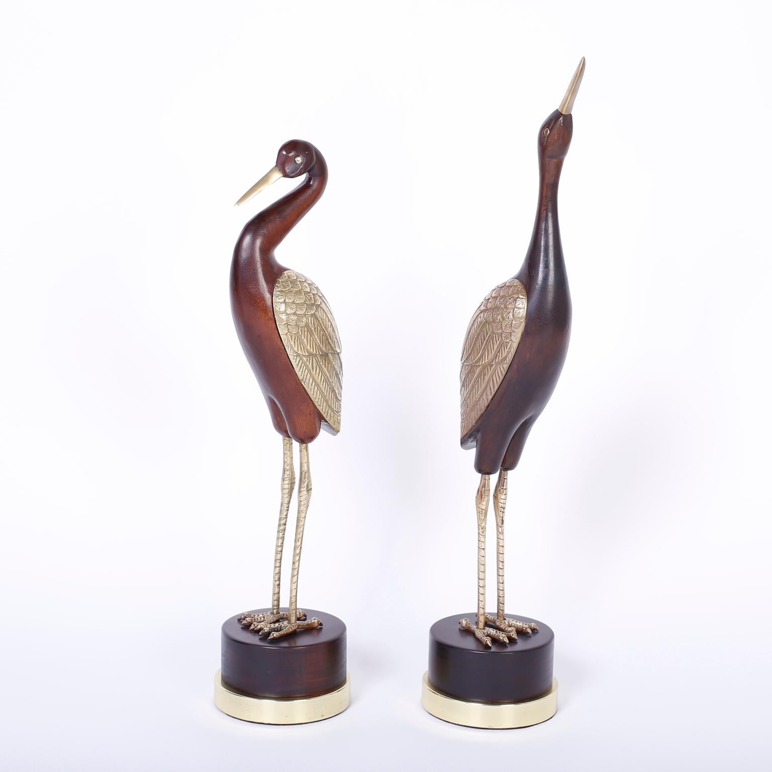 Chic pair of Mid-Century Modern stylized birds crafted in wood and brass each with its own alluring form and personality that are buffed, polished and ready for their new home.