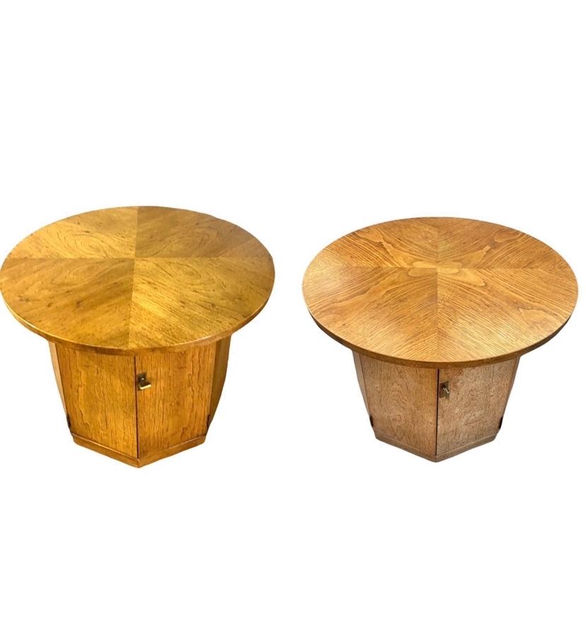 Pair of solid wood vintage mid-century round top side table / end table. Can be used as end tables or small bar. Hexagonal drum base with cabinet for built in storage. Brass pulls and magnets allow doors too open and close fully. Good vintage