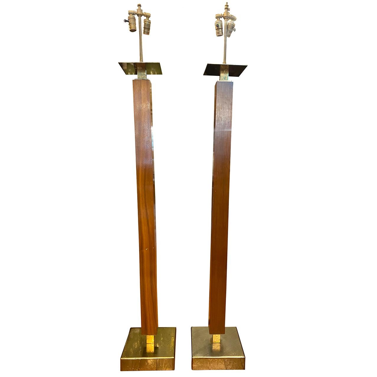 A pair of circa 1950's American mid-century wooden floor lamps with brass bases and square column bodies.

Measurements:
Height of body: 55.5