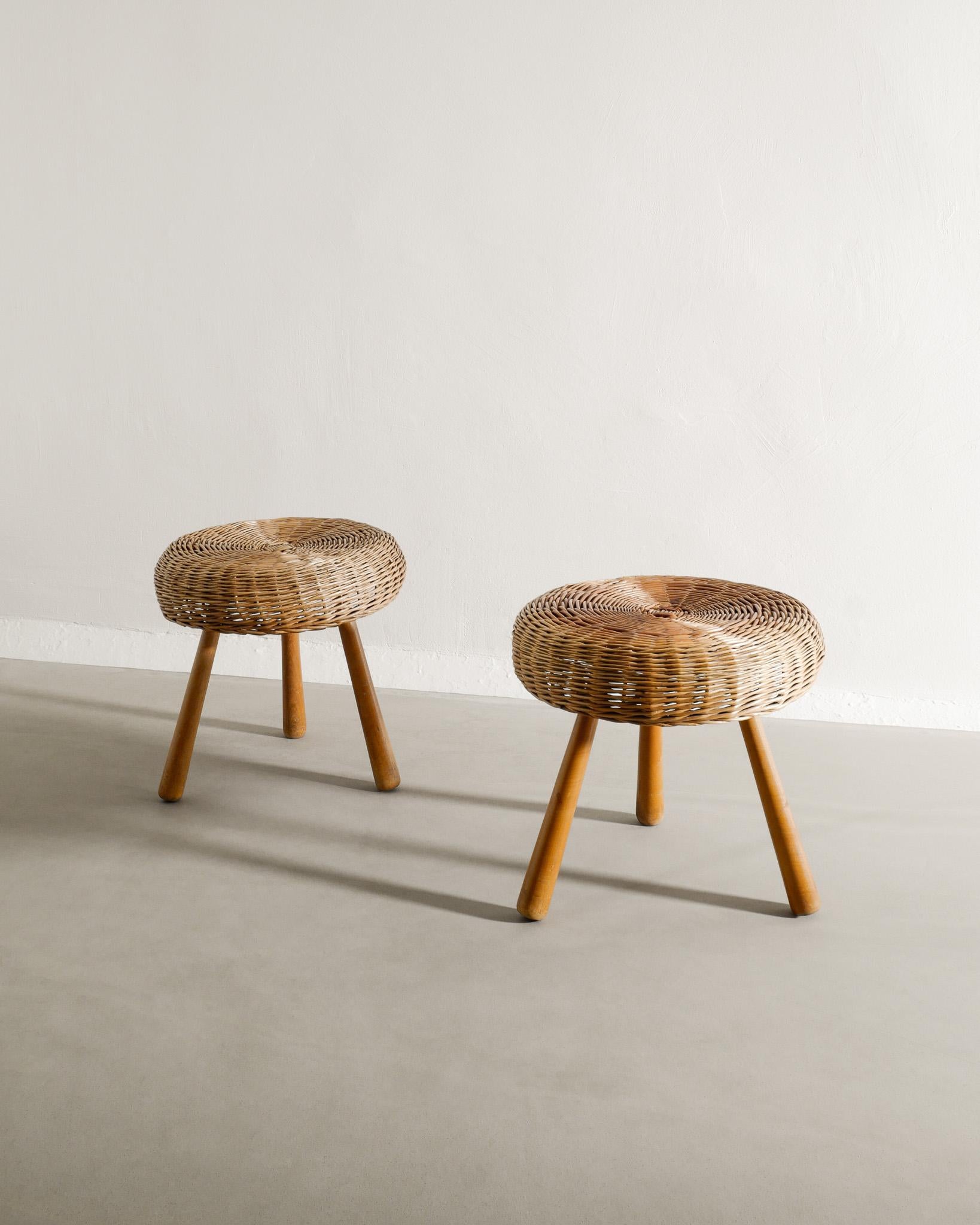 Rare pair of mid century tripod wooden and wicker / rattan low stools in style of Tony Paul most likely produced in Denmark, 1960s. In good original condition. Stable and the seats are without defects. 

Dimensions: H: 42 cm / 16.50