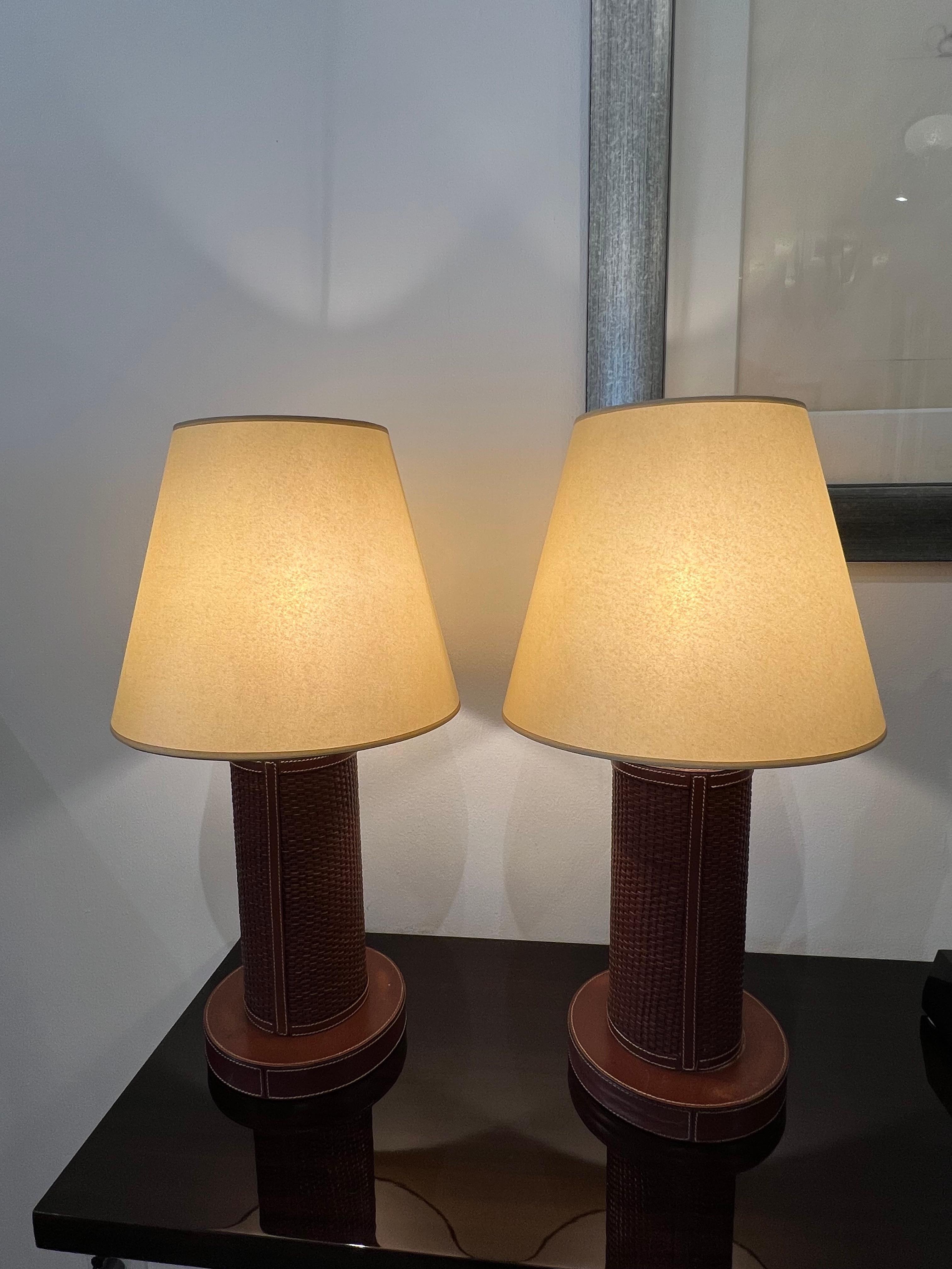 An elegant pair of woven and stitched leather table lamps in saddle color with pergamin shades.
Made in France
Circa: 1960
