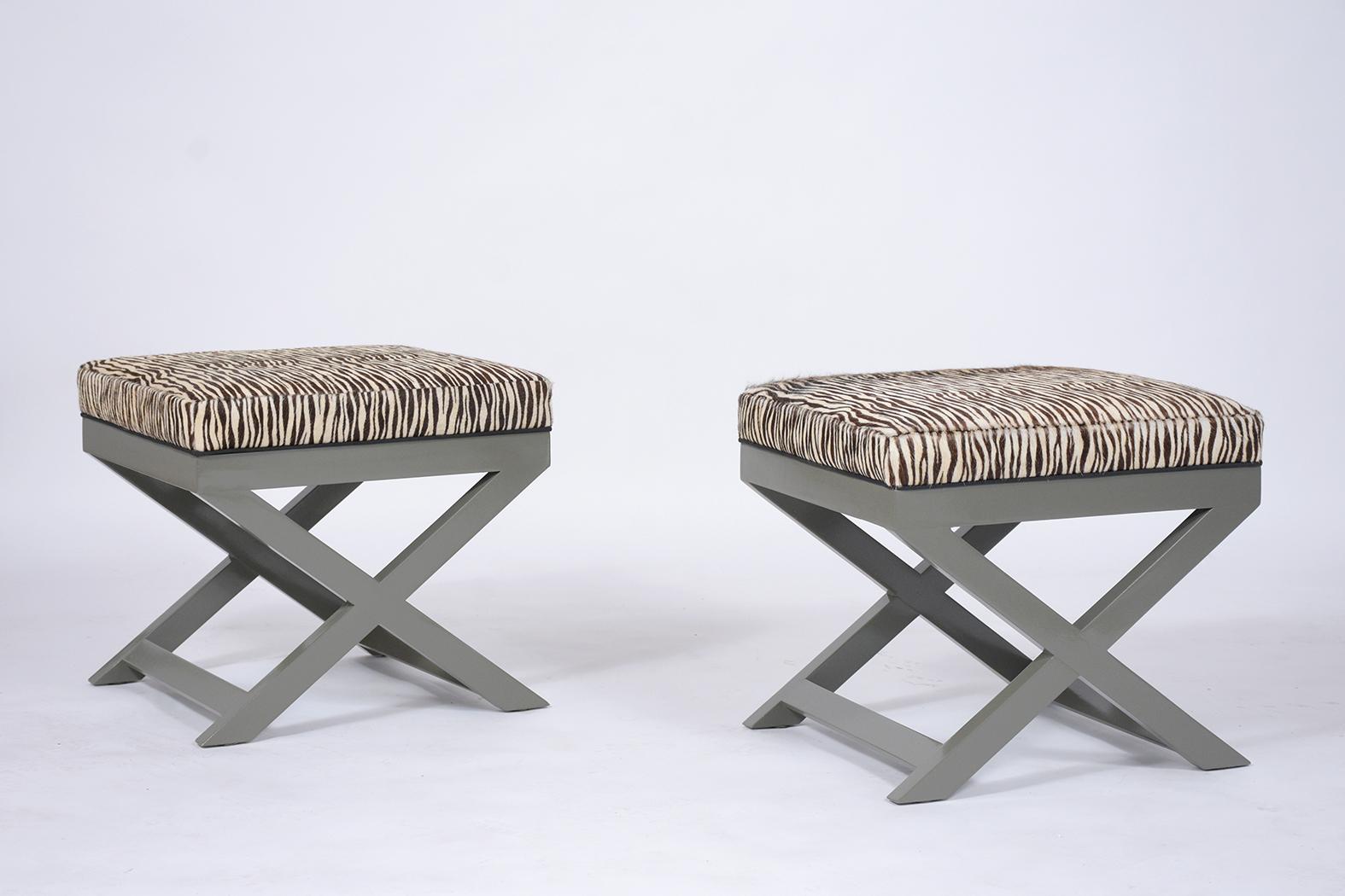 This pair of mid-century modern zebra benches are crafted out of maple wood and have been newly restored by our team of craftsmen. The stools feature an X-stretched design leg newly painted in grey color with a lacquered finish, the seats are