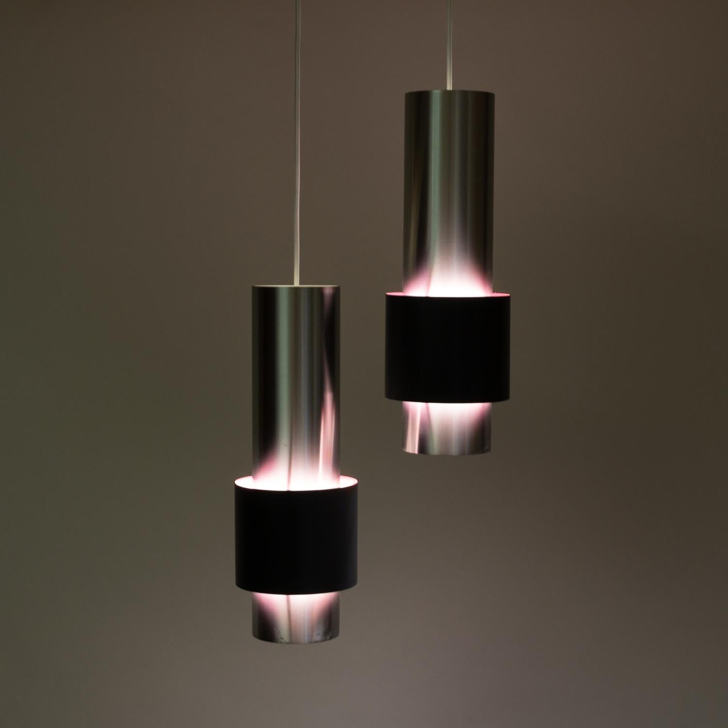 A pair of large Zenith pendants in aluminum and charcoal grey lacquered metal with hot pink interiors. Designed by Jo Hammerborg for Fog & Mørup, Denmark, 1960s.
 
  