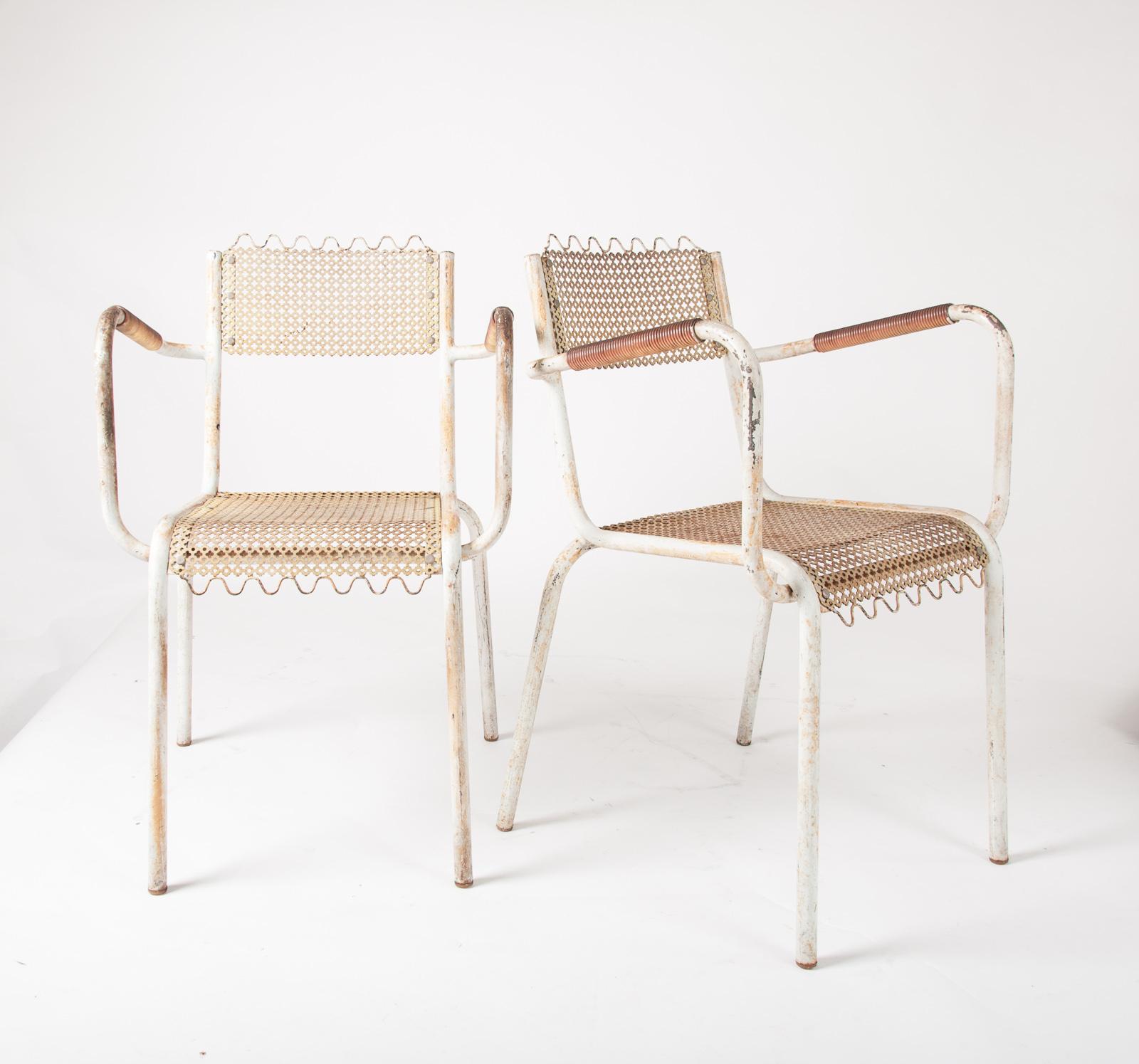 Pair of French metal armchairs in the style of Mathieu Matégot with tubular steel frames, nylon wrapped arms and perforated steel seats and backs riveted to the frames, France, circa 1950

(Priced for the pair).
 