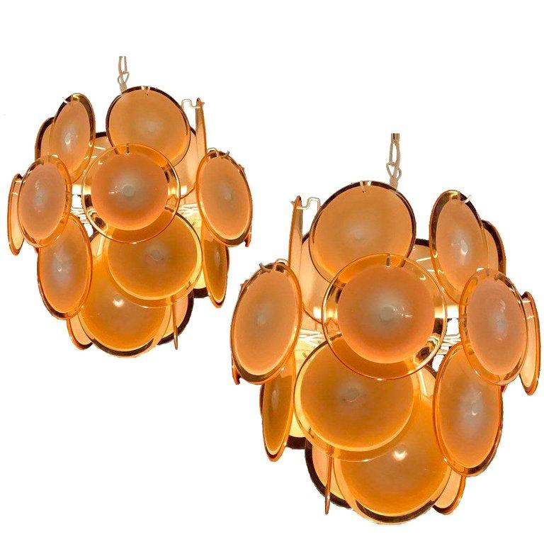 Each chandelier is formed by 24 honey discs of precious Murano glass are arranged on floor levels. Nine lights. Measures: Height without chain 50 cm.
Available also with white and pink discs.