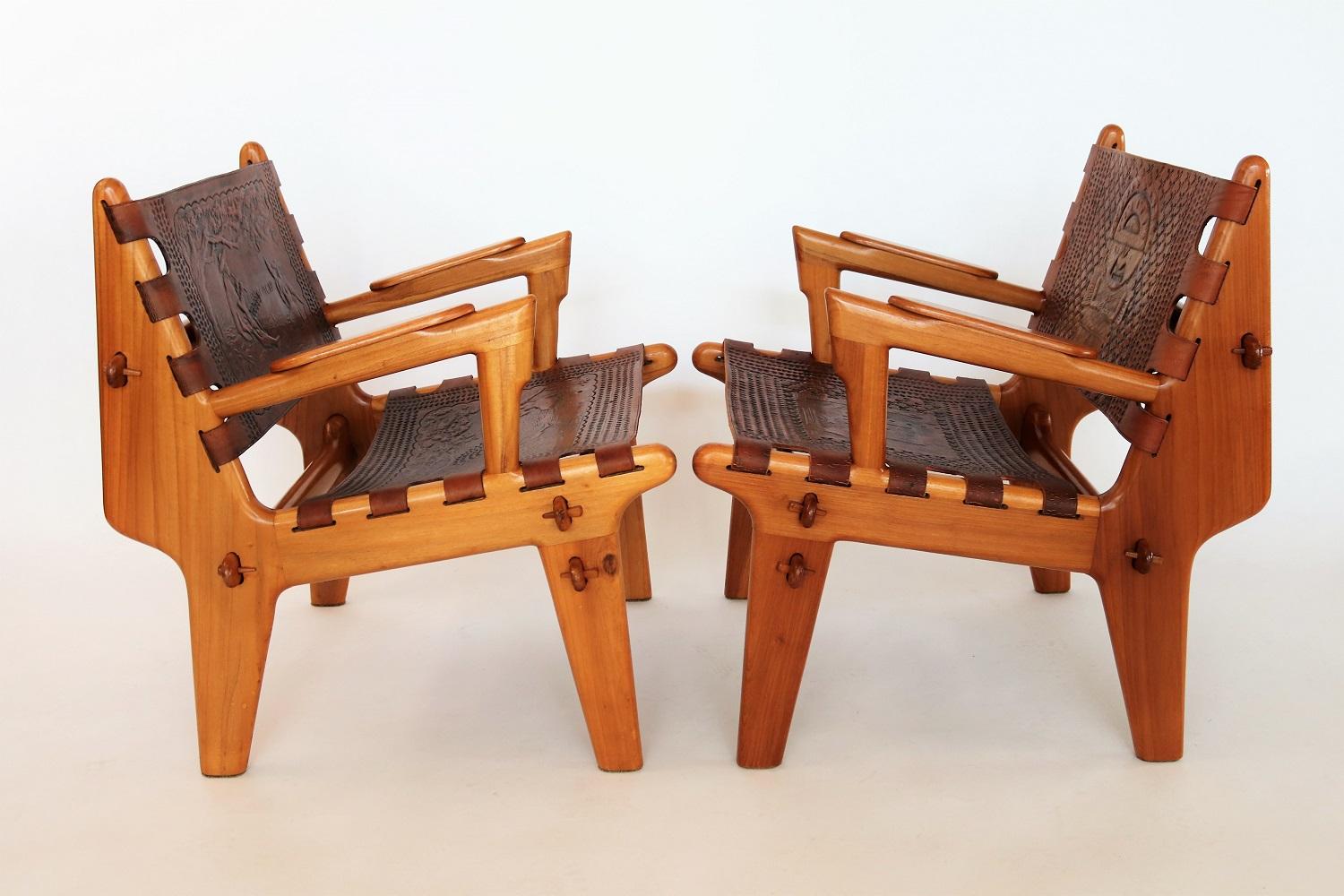 Beautiful pair of armchairs designed by Angel I Pazmino for Muebles De Estilo, Ecuador, circa 1960s.
Both armchairs are made of cherrywood and thick leather and are slightly different from each other in color.
The leather is fixed with wooden stakes