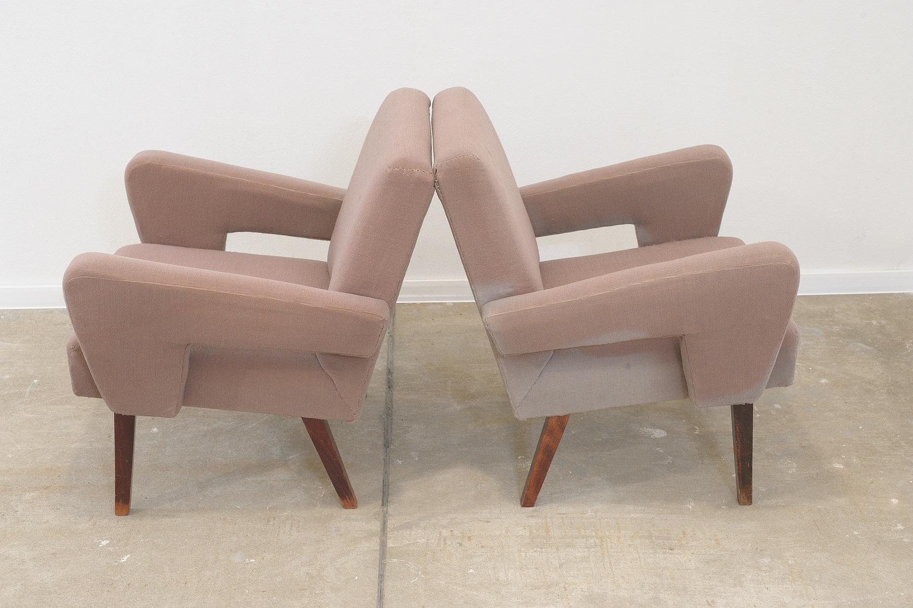 A pair of midcentury armchairs, made by Jitona company in the former Czechoslovakia in the 1970s.  The chairs are fully functional, have beech wood legs.  They show signs of age and using, the fabric is sun faded on the sides. Price is for the