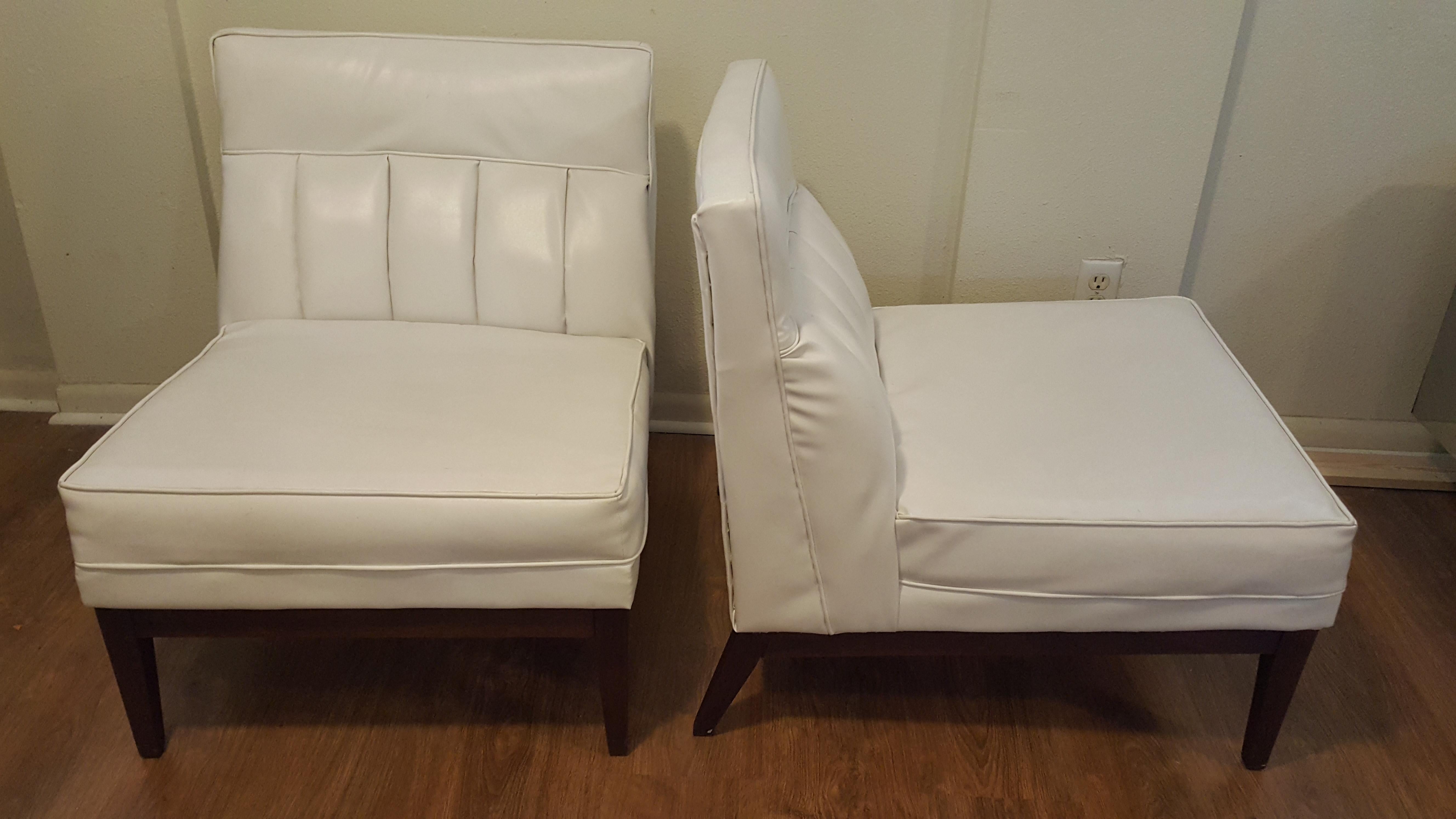 Beautiful pair of white petite slant leg armless slipper chairs.