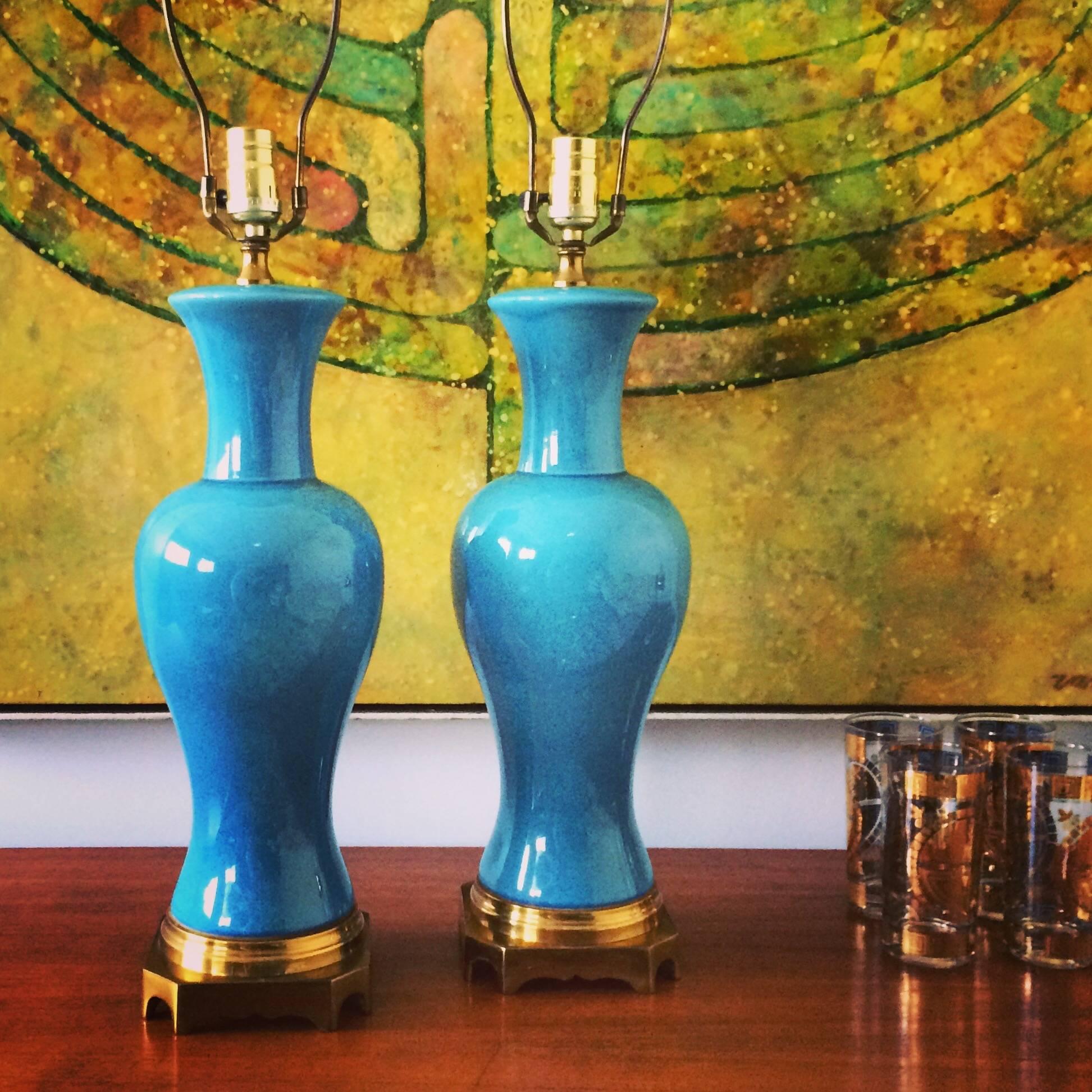 A pair of midcentury Asian style turquoise table lamps with a solid brass base. In beautiful original condition. Patinated brass base, harp and finial. Shades not included. Age appropriate wear.

Measurements: Measurements to top of receptacle 22