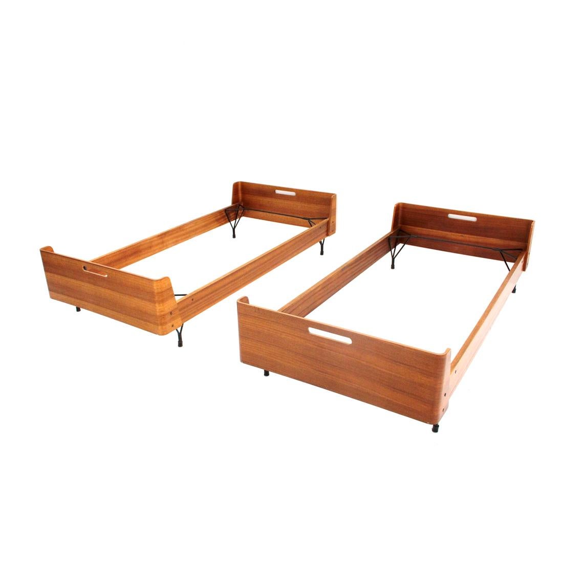 Pair of beds produced in the 1950s by Rima and designed by Gastone Rinaldi.
Teak multi-layer structure with curved corners.
Handle on headboard and footboard.
Two bases in black painted metal.
Good general condition, some signs and lack of