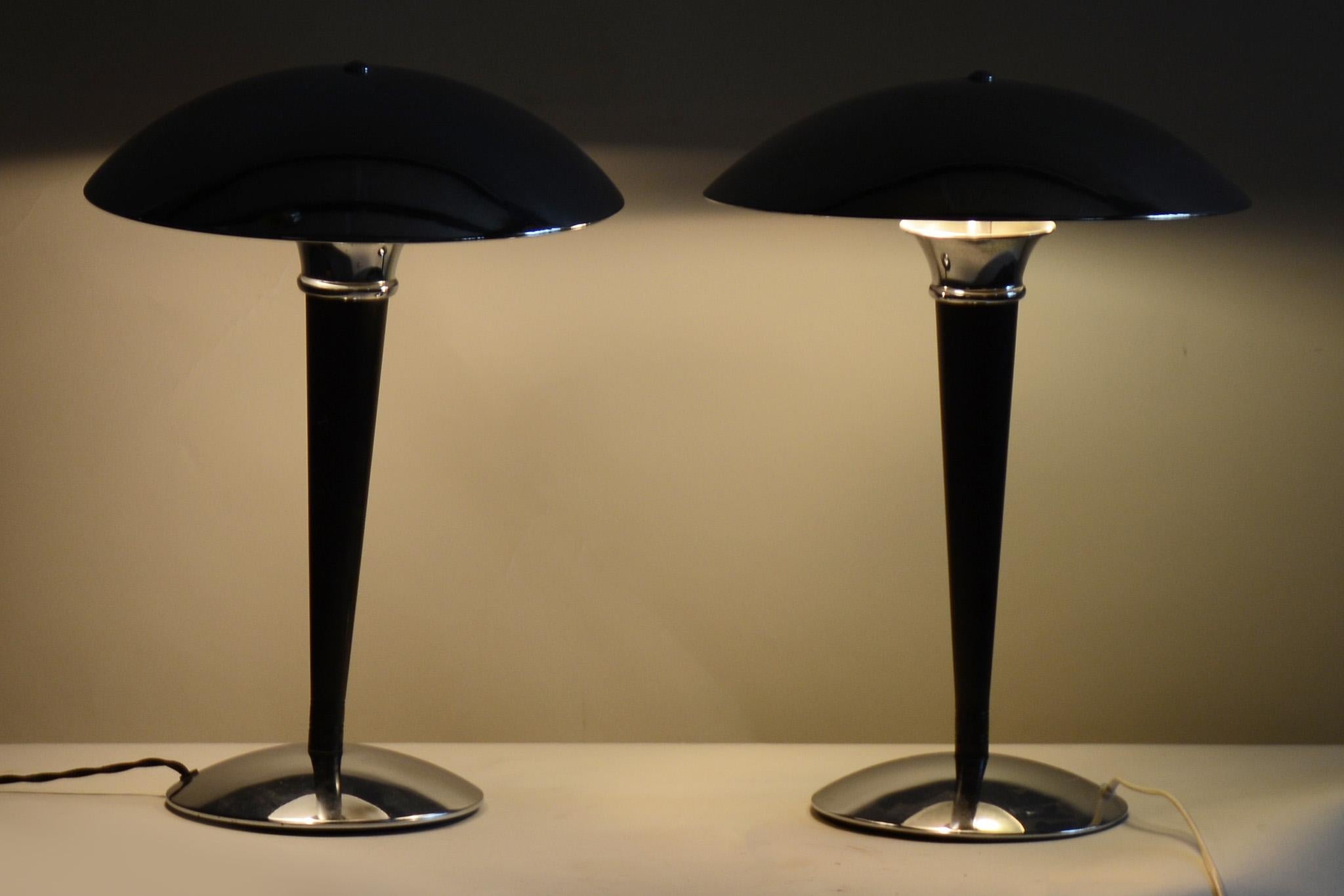 Pair of midcentury black table lamps with new electrification.

Period: 1950-1959
Source: Germany
Material: Chrome-Plated Steel. Black Lacquer

It has been fully restored by our professional refurbishing team in Czechia according to the