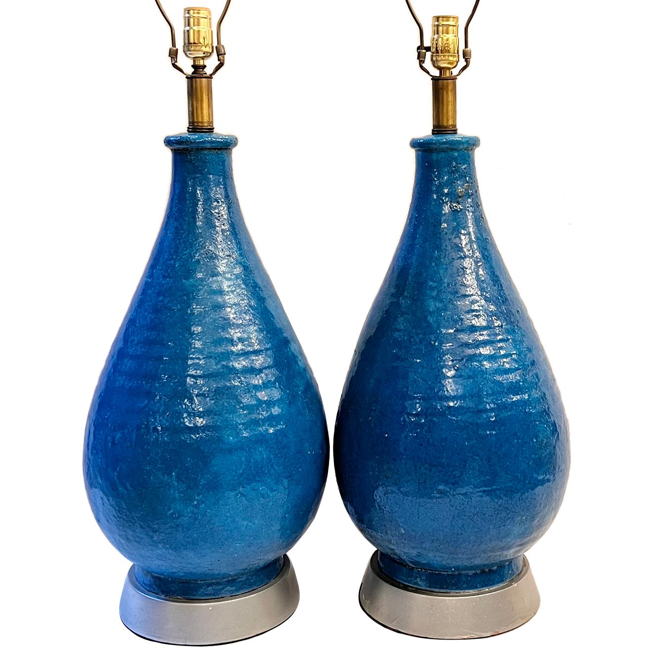 Pair of circa 1960's Italian large blue ceramic table lamps with painted wooden bases.

Measurements:
Height of body 23