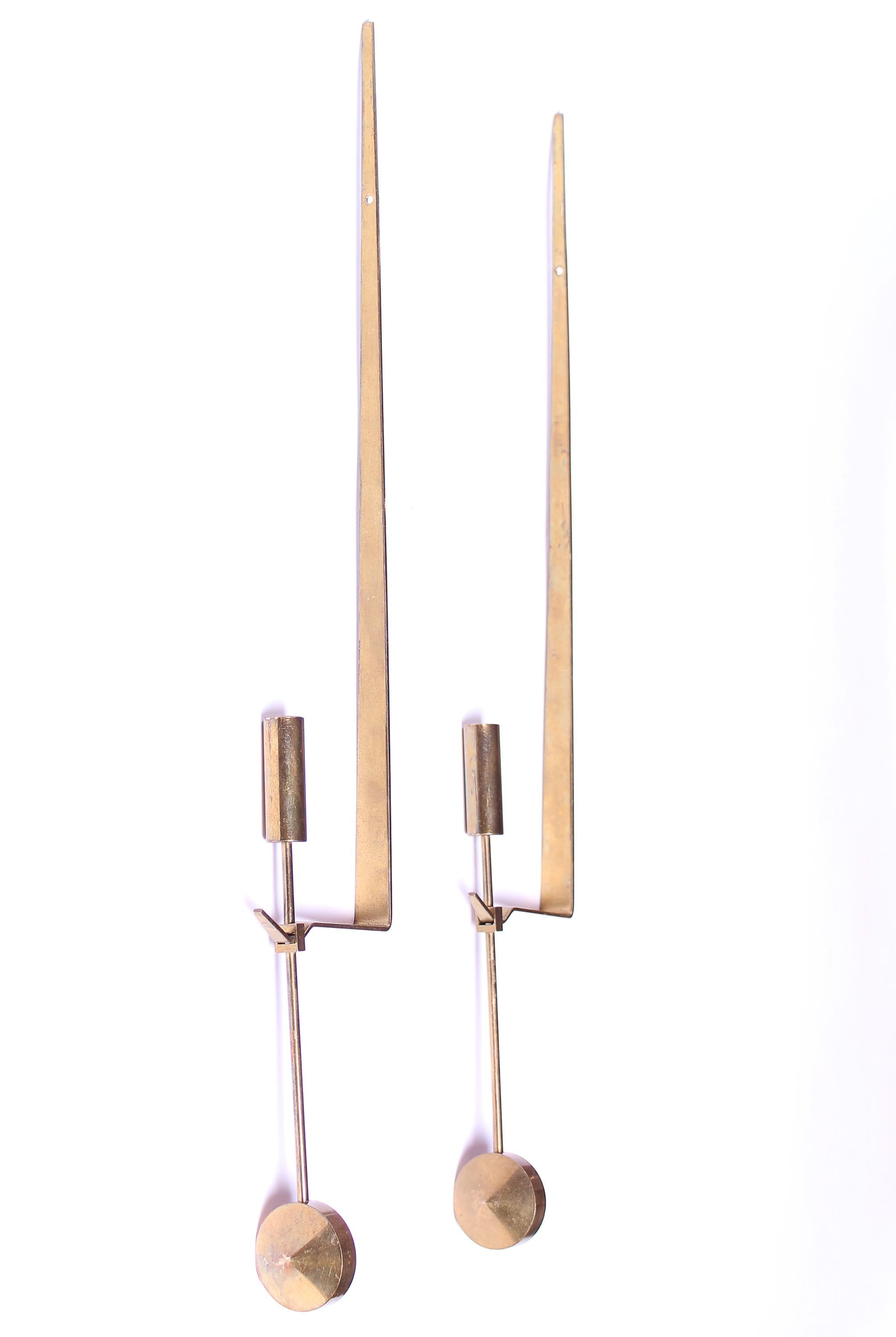 A pair of brass pendant candleholders designed by Pierre Forsell for Skultuna, 1970s. Very good vintage condition.