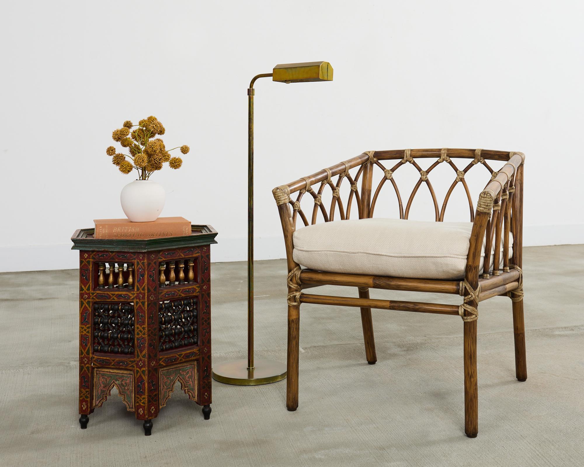 Mid-century modern pair of patinated brass pharmacy floor lamps attributed to Casella. The lamps feature an adjustable column that rises from 40 inches high to an astonishing 58 inches high. Made in the manner and style of Casella lighting with a
